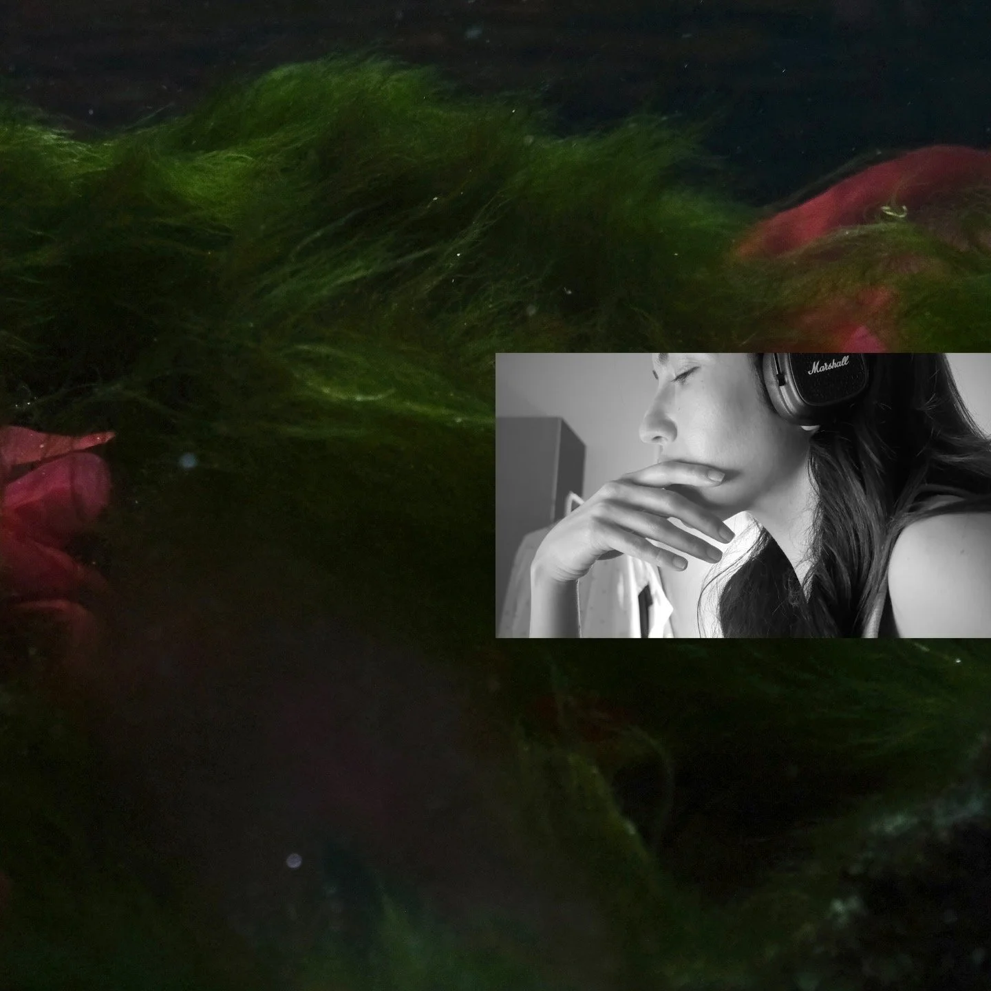 A woman with long dark hair wearing headphones, resting her chin on her hand with her eyes closed, in a gray-scale photo overlaid onto a colorful background of green and red hair underwater.