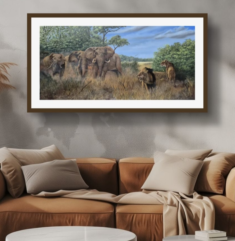 Painting of elephants and lions in a savannah landscape with trees and blue sky, hanging on a gray wall above a beige sectional sofa with pillows.
