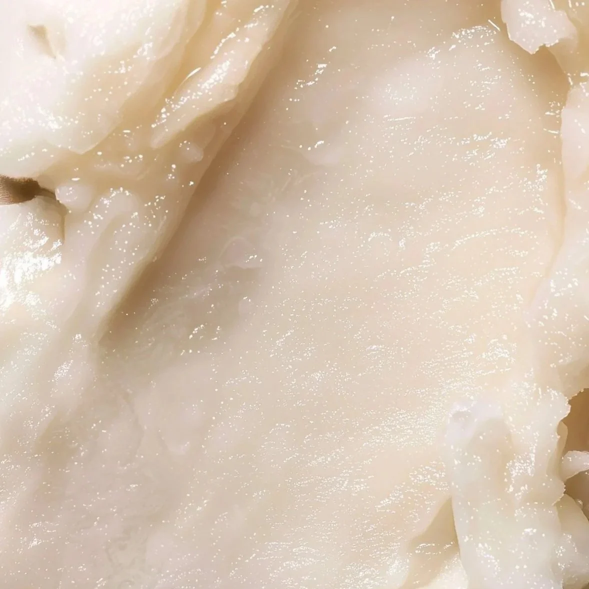 Close-up of a peeled potato with smooth, white flesh and some remaining skin edges.