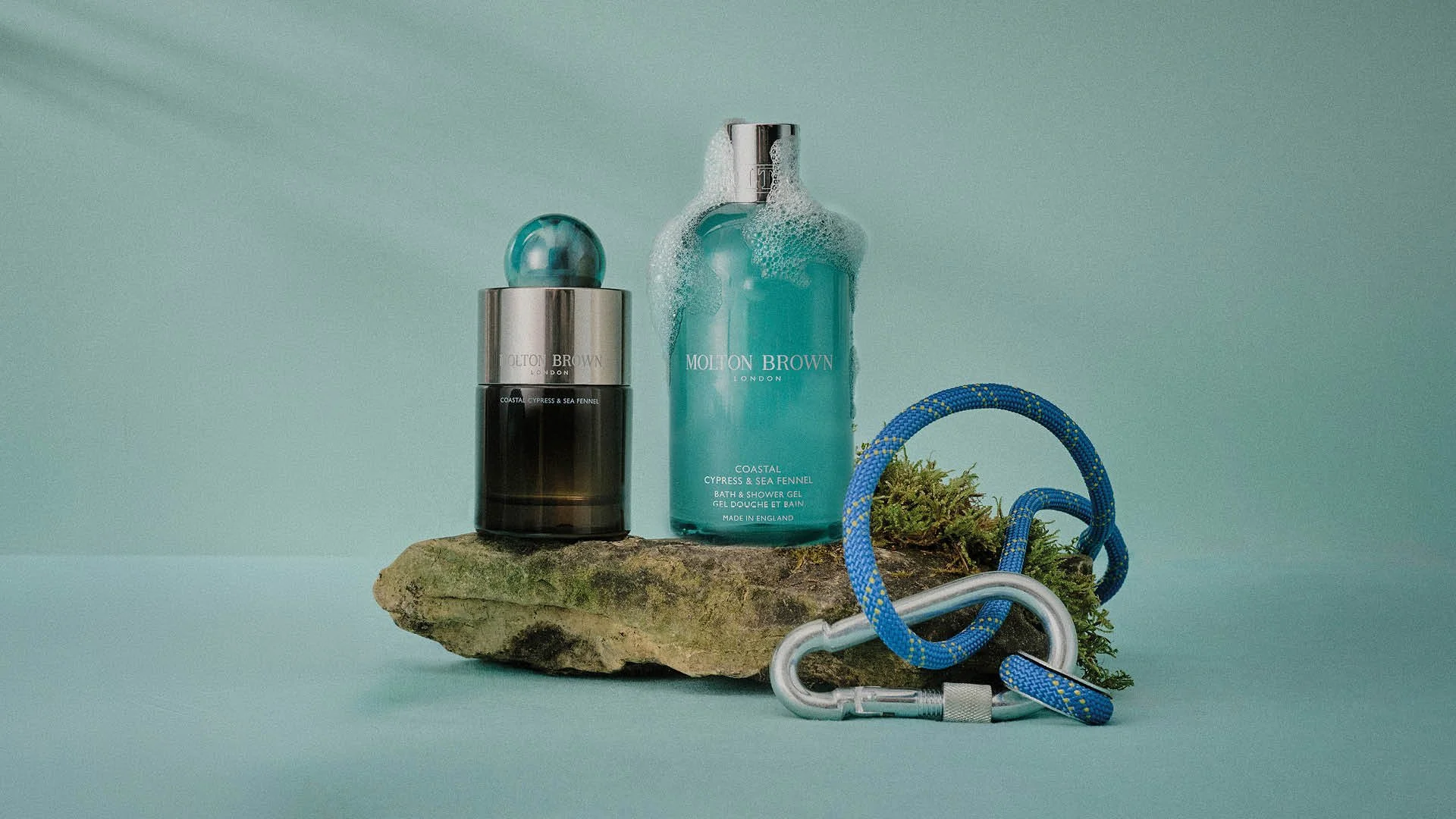 Molton Brown fragrance collection styled within a cohesive Evergreen colour system using a tonal backdrop.