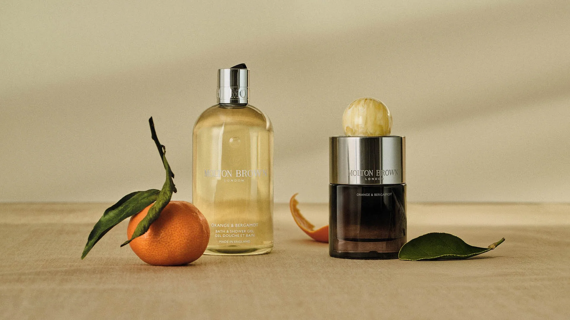 Molton Brown fragrance collection styled within a cohesive Evergreen colour system using a tonal backdrop.