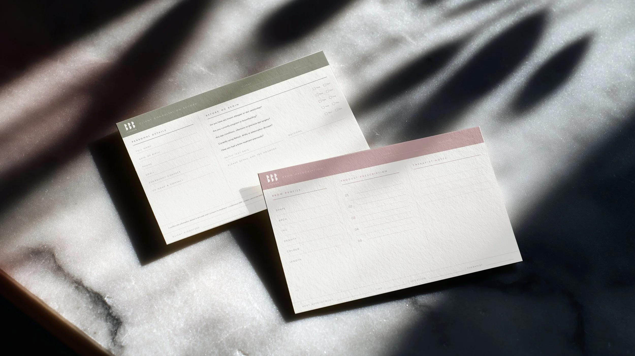 Printed consultation and brow prescription cards on marble