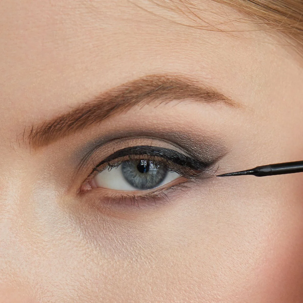 Close-up sequence showing eye liner application