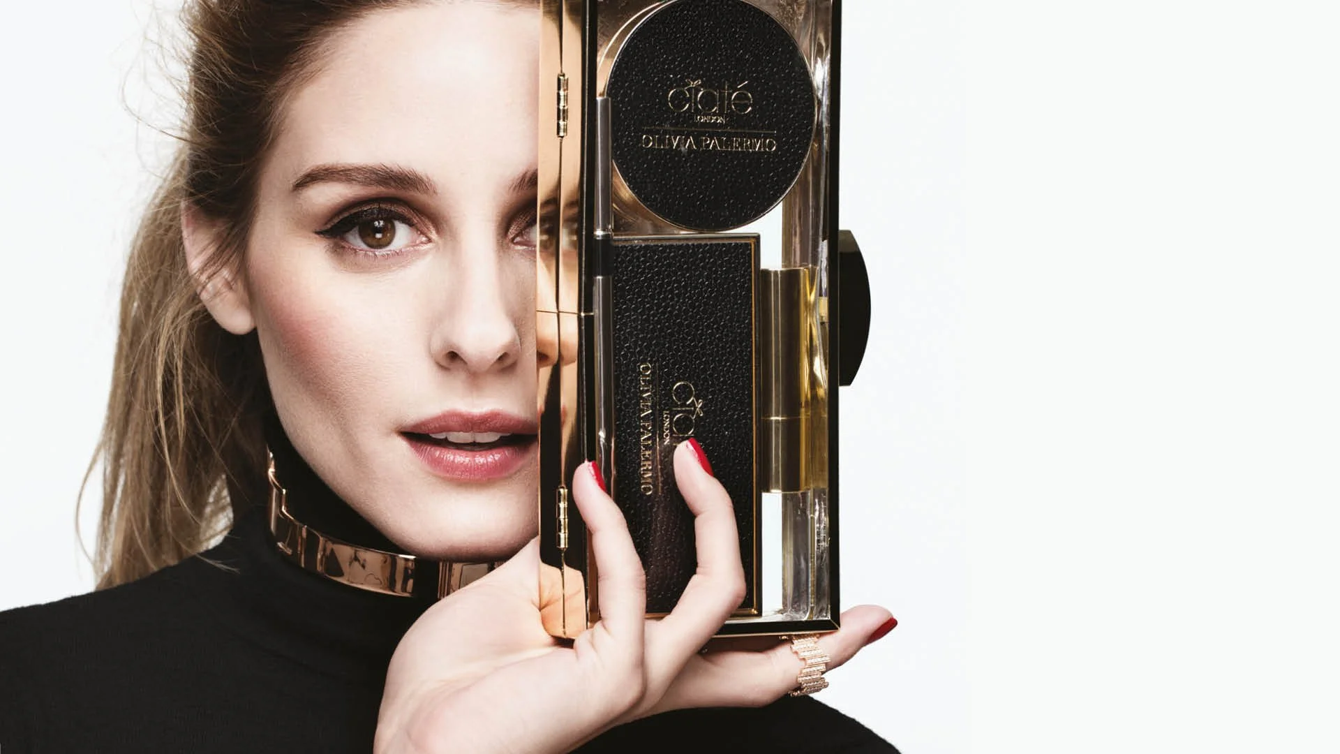 Olivia Palermo photographed holding the Ciaté London x Olivia Palermo hero makeup palette, styled in a black high-neck look against a clean studio backdrop.