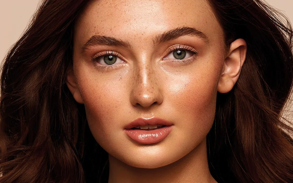 Woman with glowing skin and glossy lips