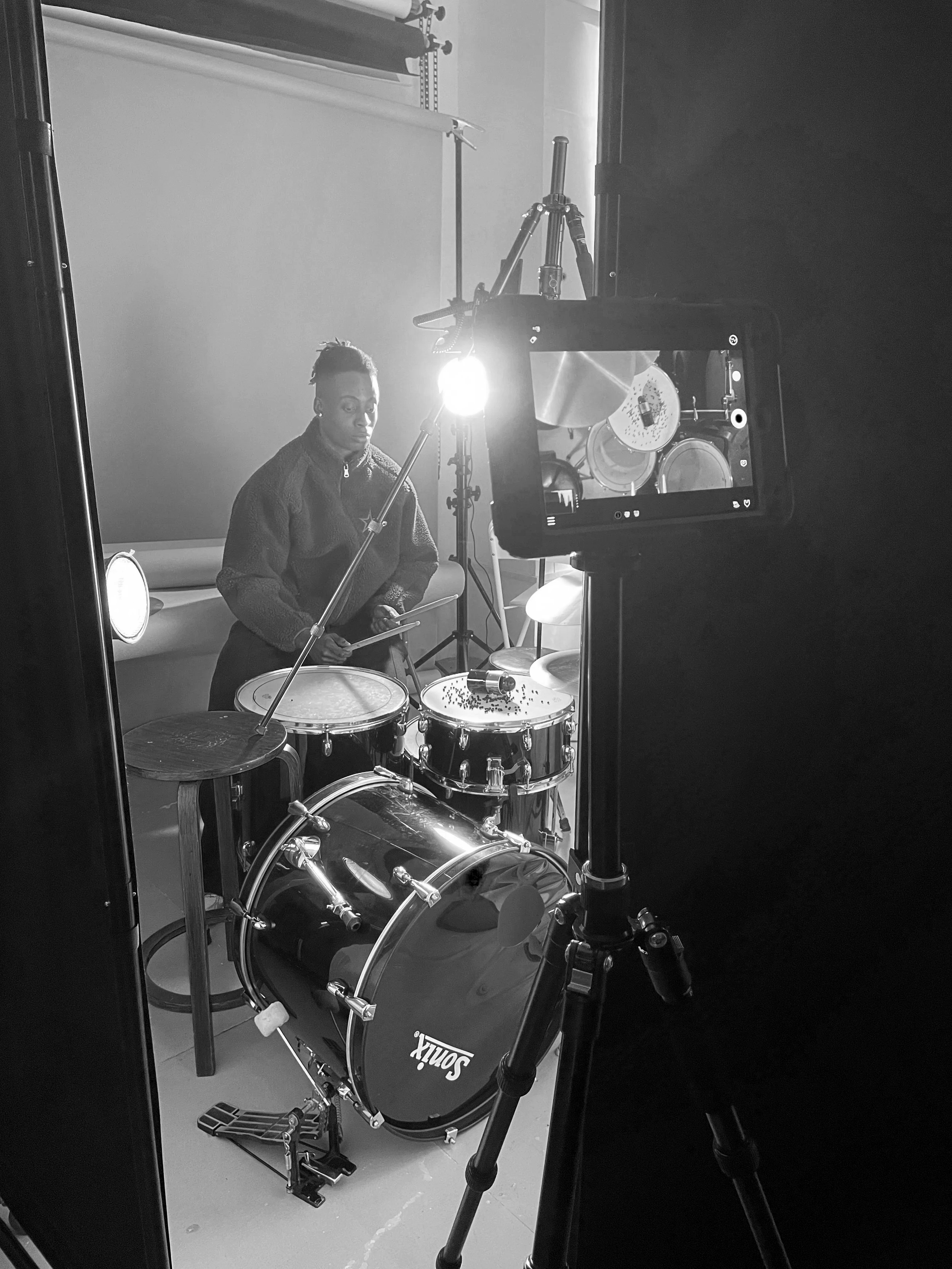 Studio rig setup filming fragrance product with lighting equipment