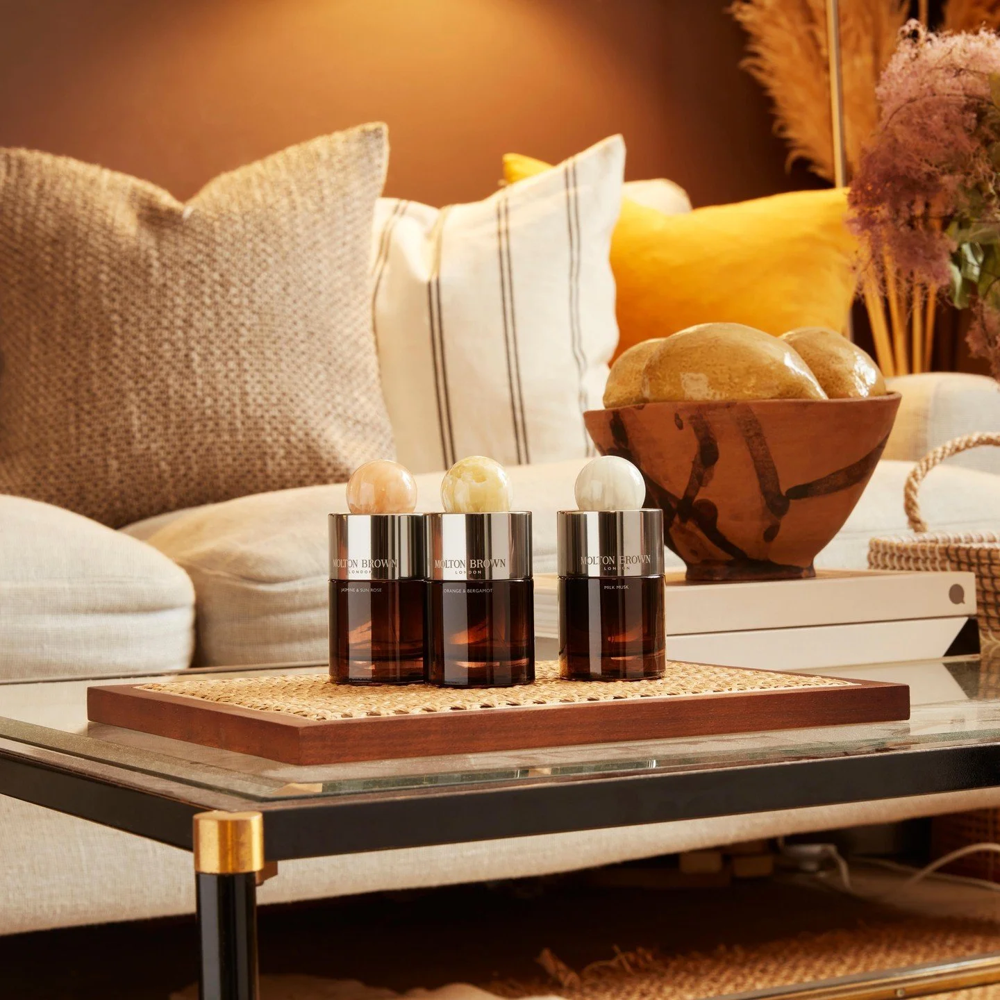 Fragrance collection arranged on table with textured props