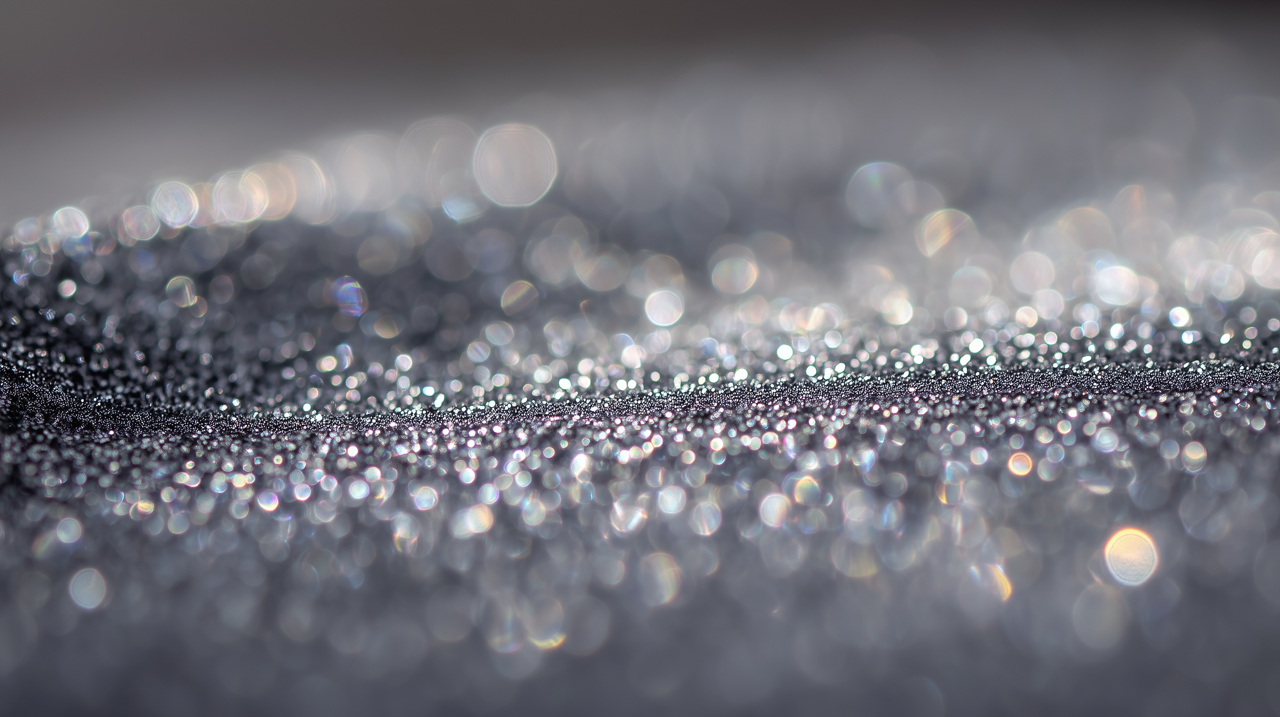 Close-up of shimmering, glittering silver dust particles reflecting light
