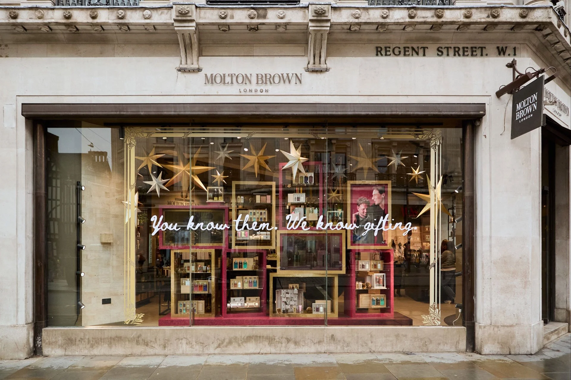 Molton Brown store window exterior featuring You Know Them, We Know Gifting Christmas campaign visuals.
