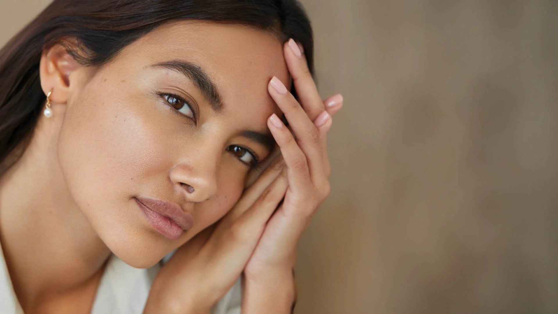 | Beauty portrait highlighting clean skin and softly defined brows