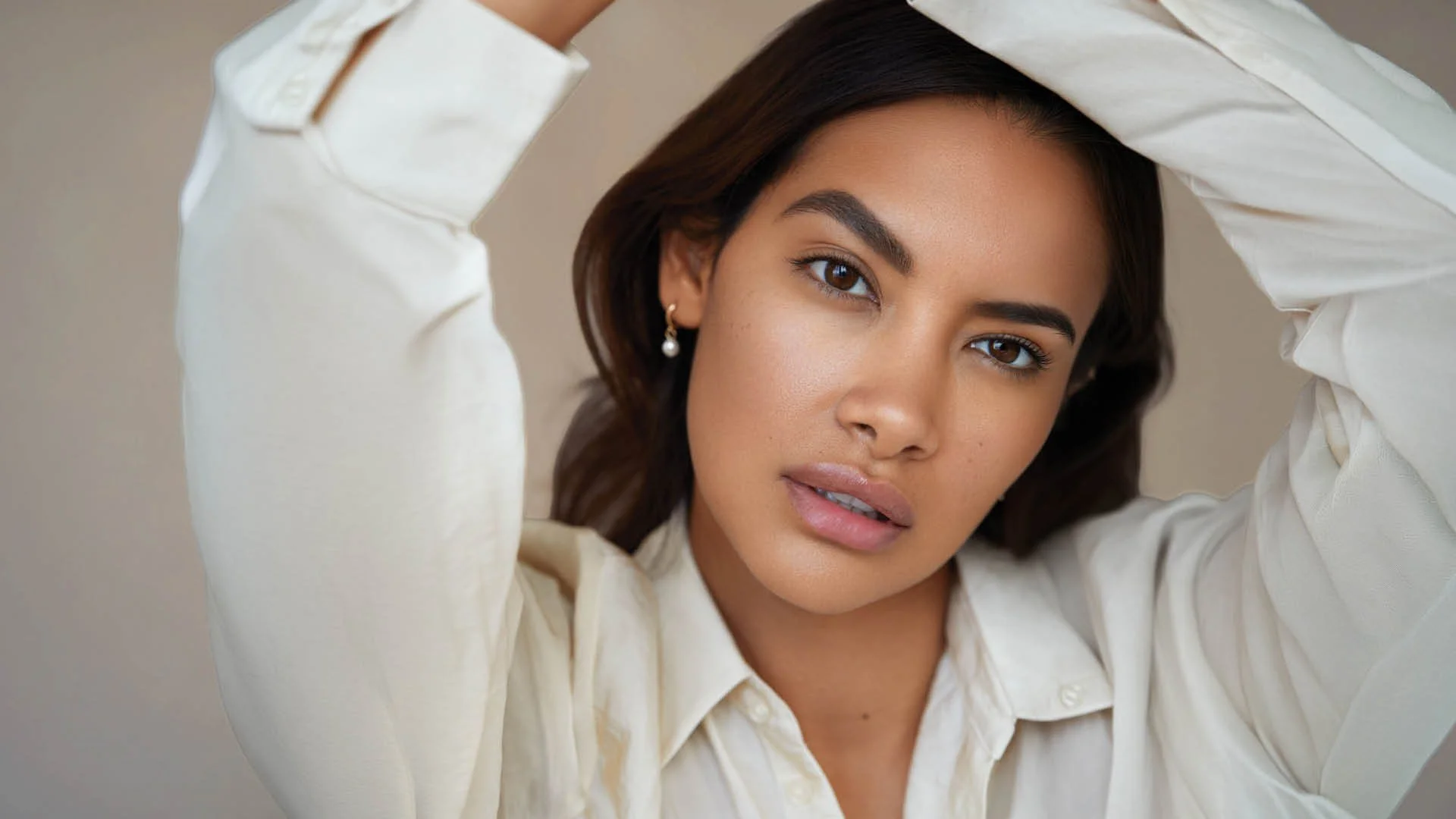 Close-up portrait of woman with natural brows and minimal makeup