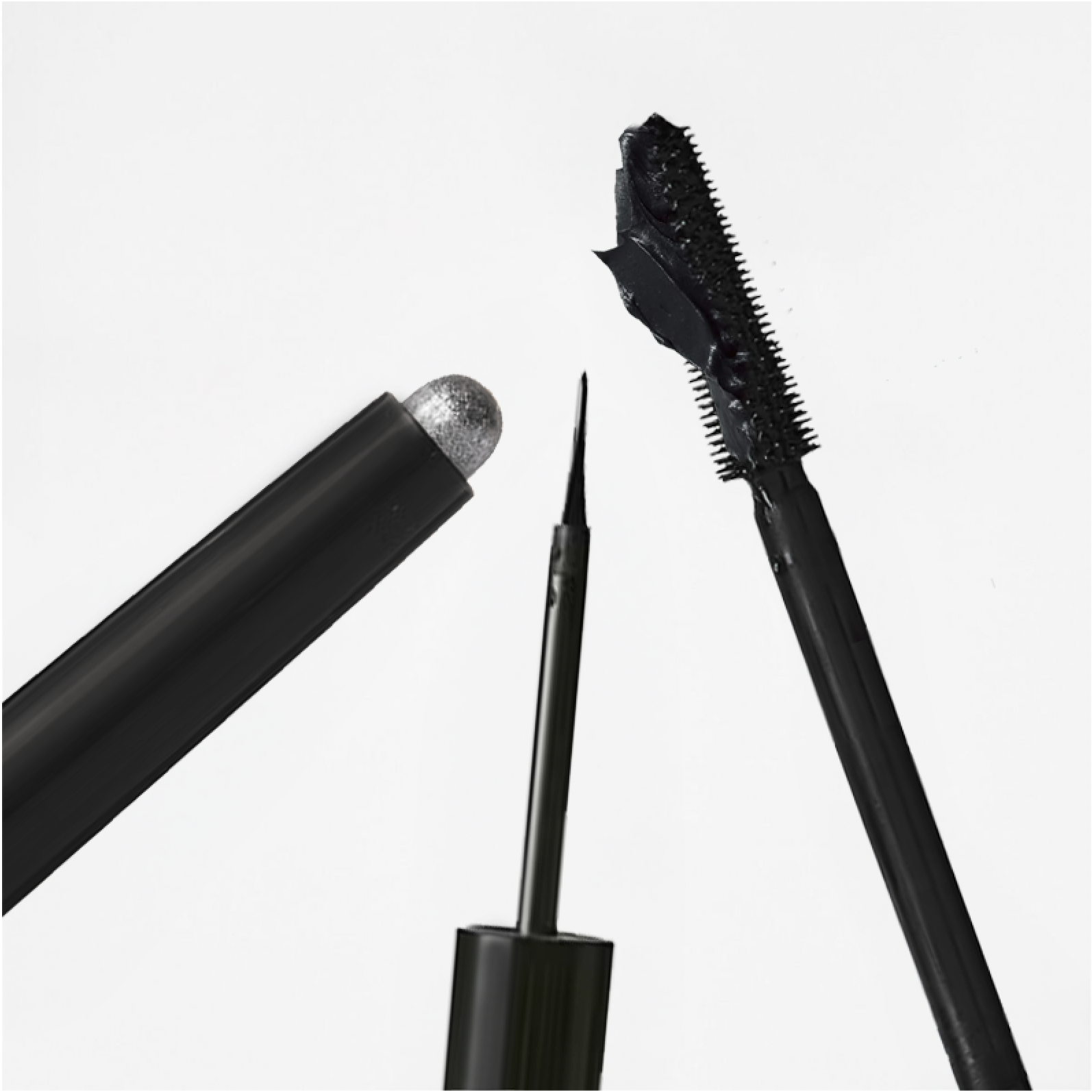 Close-up of black cosmetic makeup products including an eyeliner, mascara wand, and glitter eyeshadow stick against a white background.