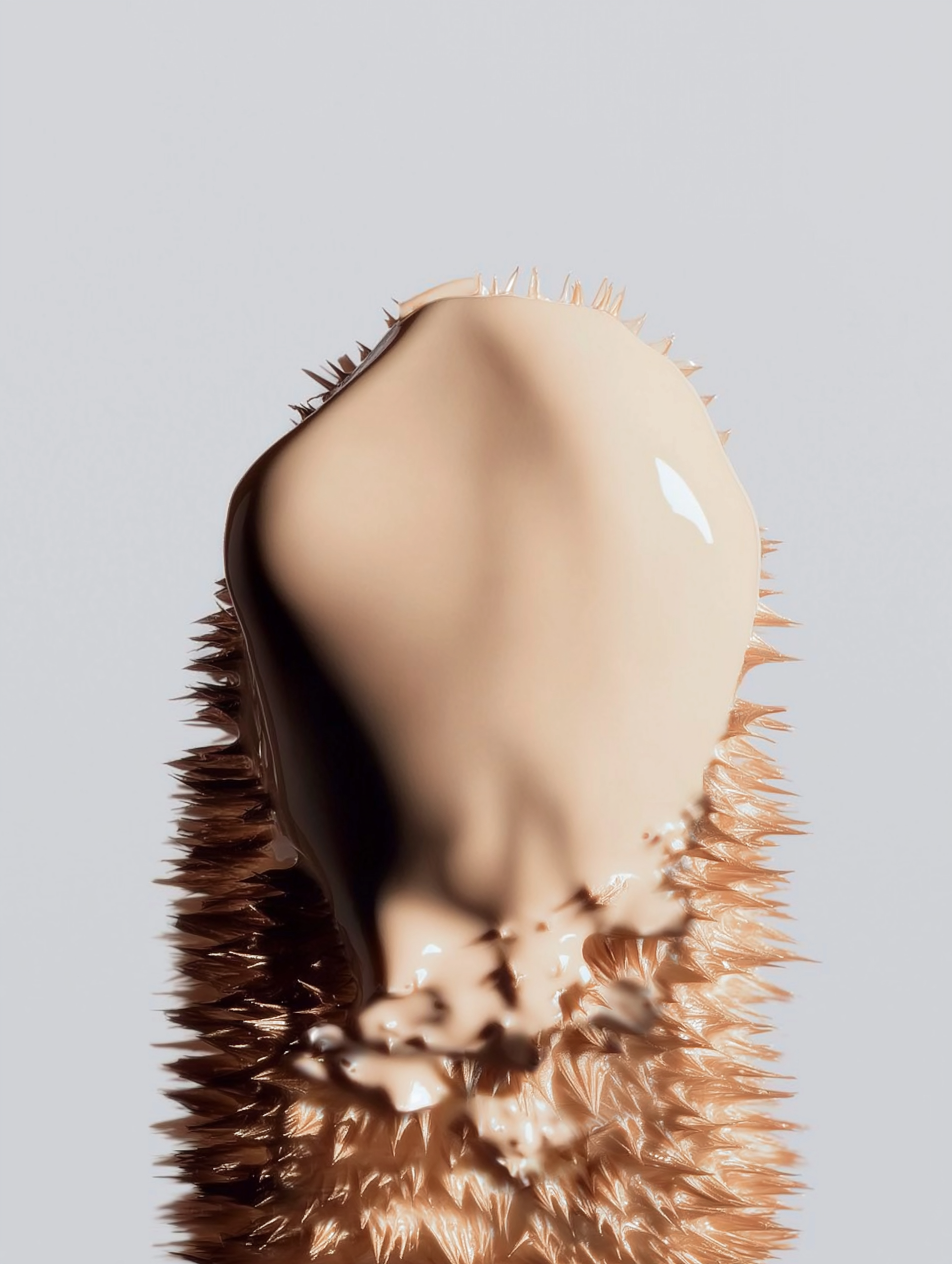 Close-up of a hedgehog with a smooth face and spiky brown fur on its body, captured against a light gray background.