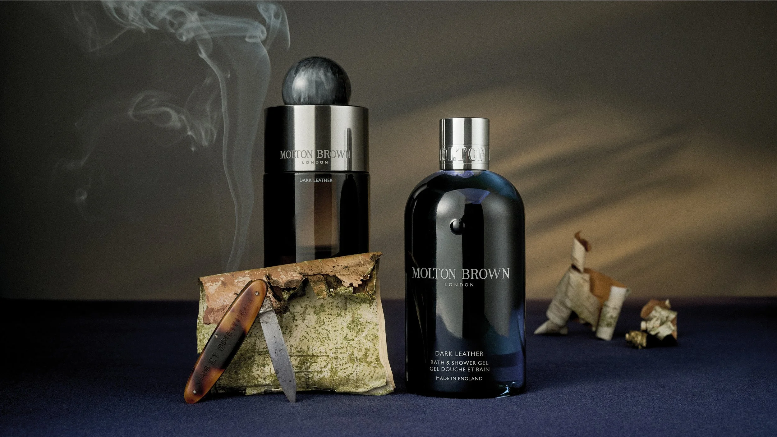 Molton Brown fragrance collection styled within a cohesive Evergreen colour system using a tonal backdrop.