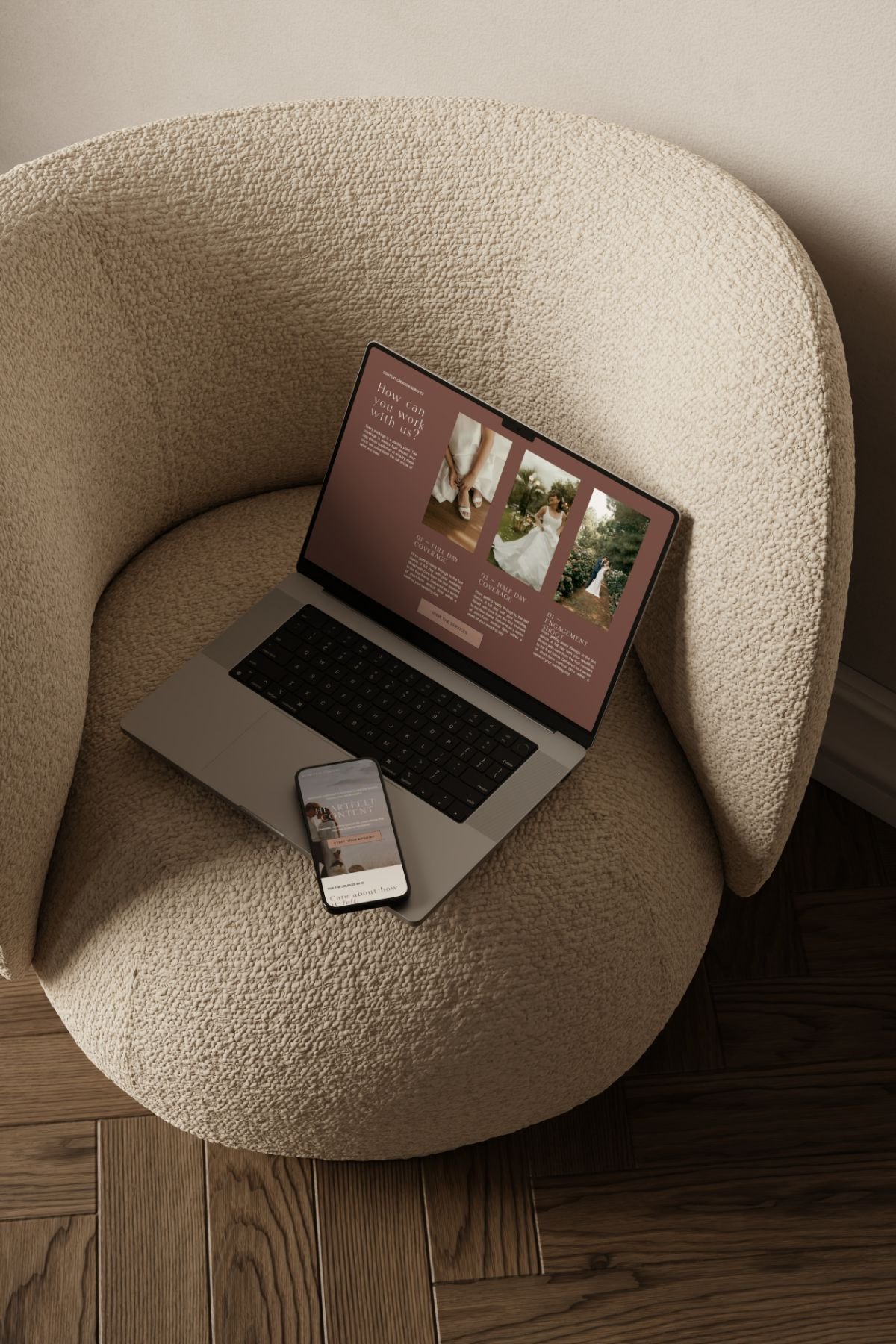A laptop and smartphone displaying a wedding website rest on a cream, textured chair—perfect to attract luxury wedding clients.