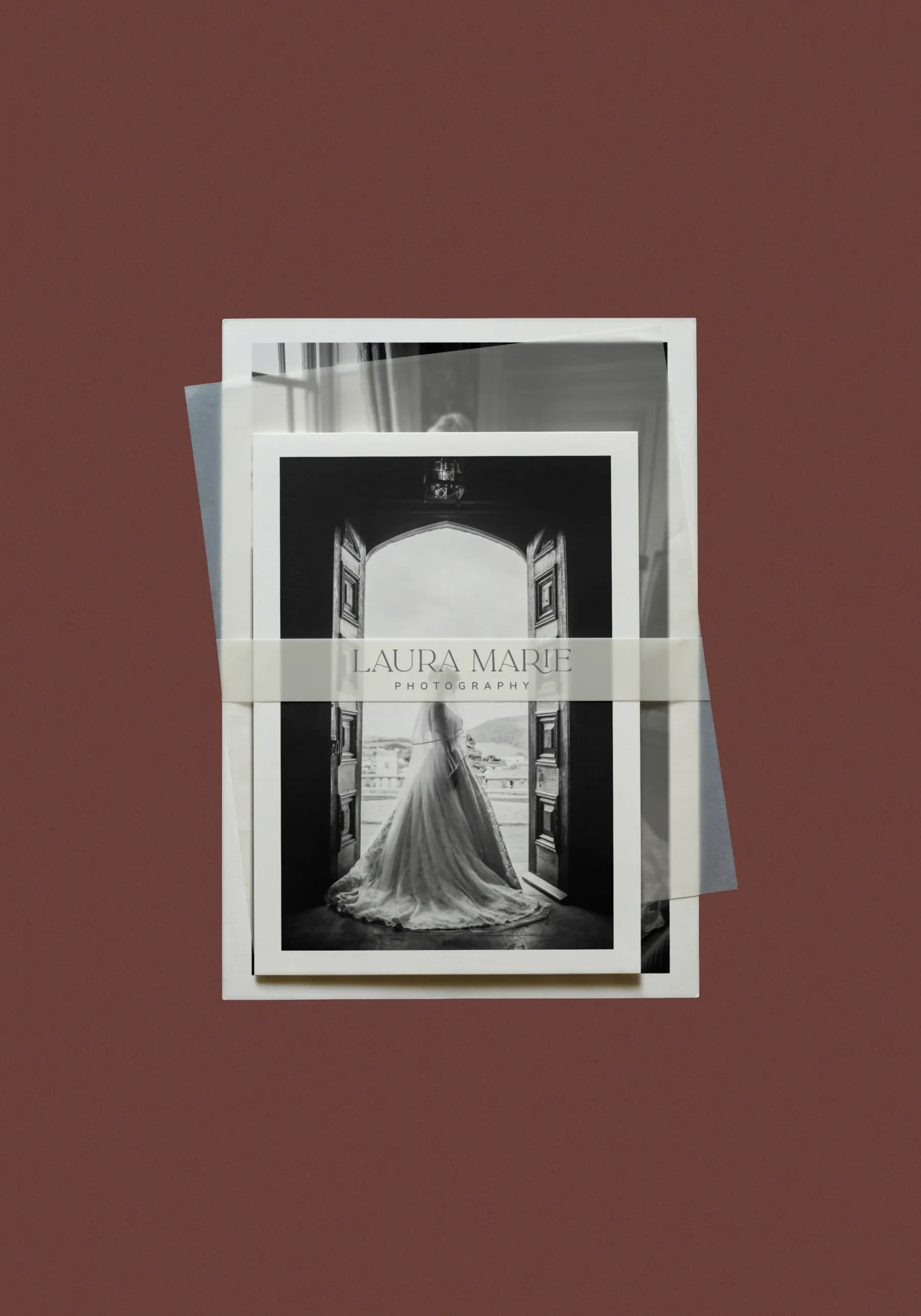 A black-and-white photo of a bride by a window, packaged with wedding photographer branding labeled Laura Marie Photography.