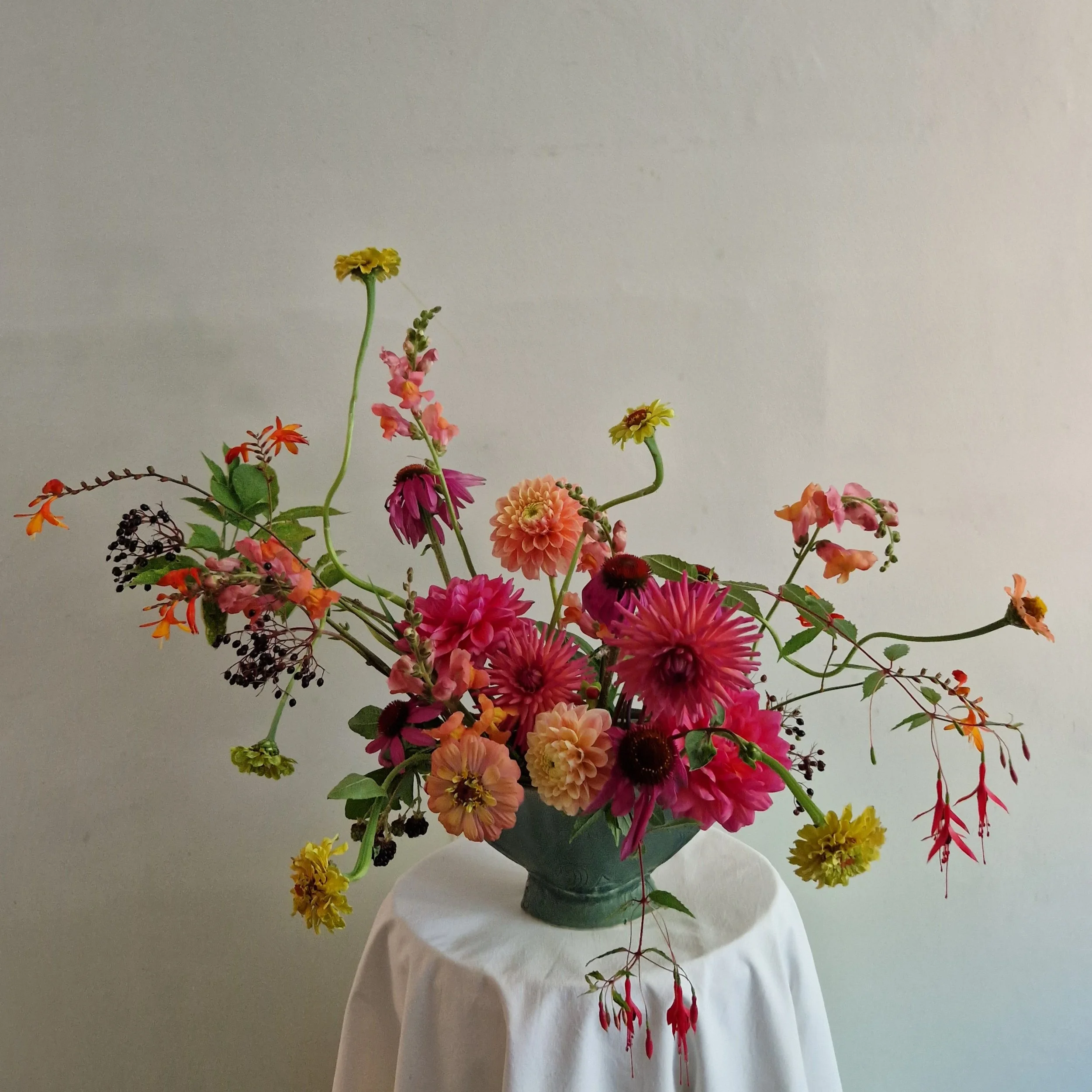 sculptural floral arrangement, rich orange and pink