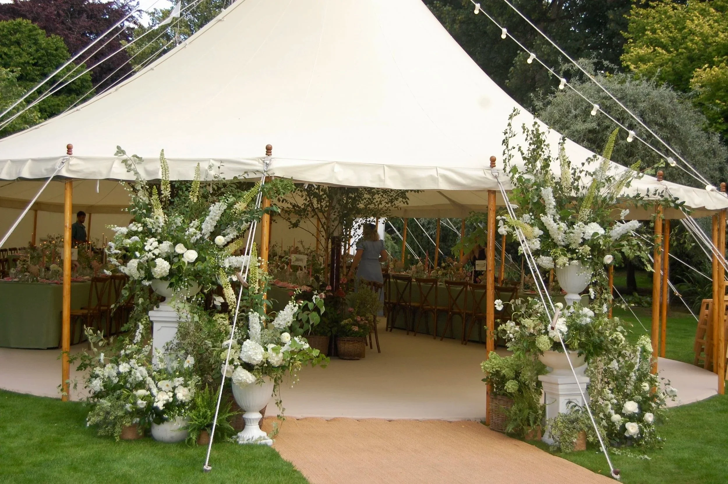 marquee entrance white floral arrangement