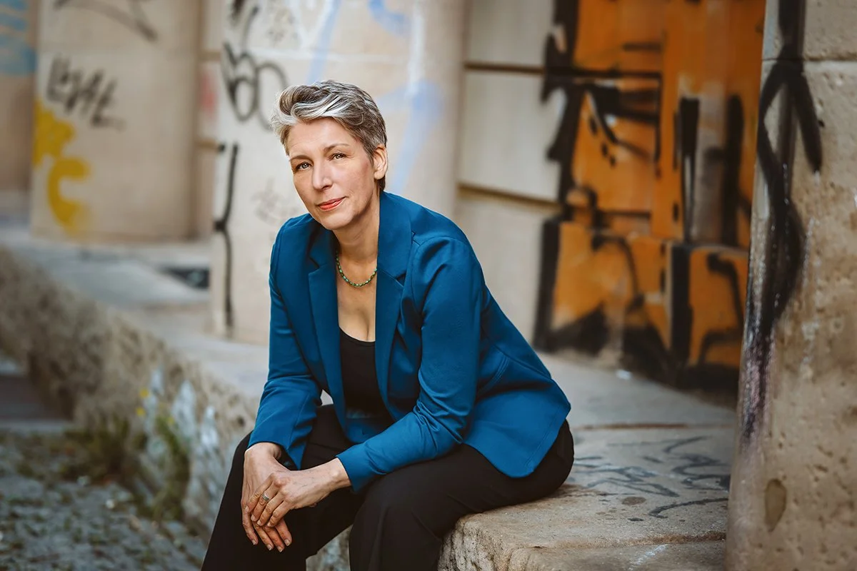 Frau sitzt in Berlin an Graffiti Wall