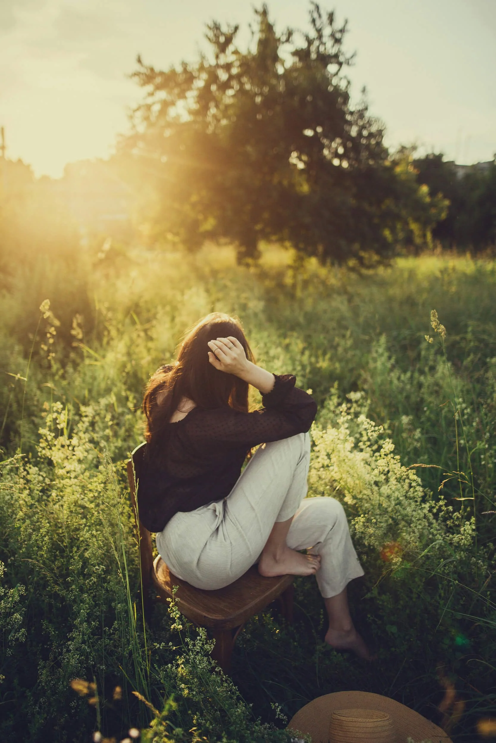 Woman relaxing in field after massage with Tripp Within