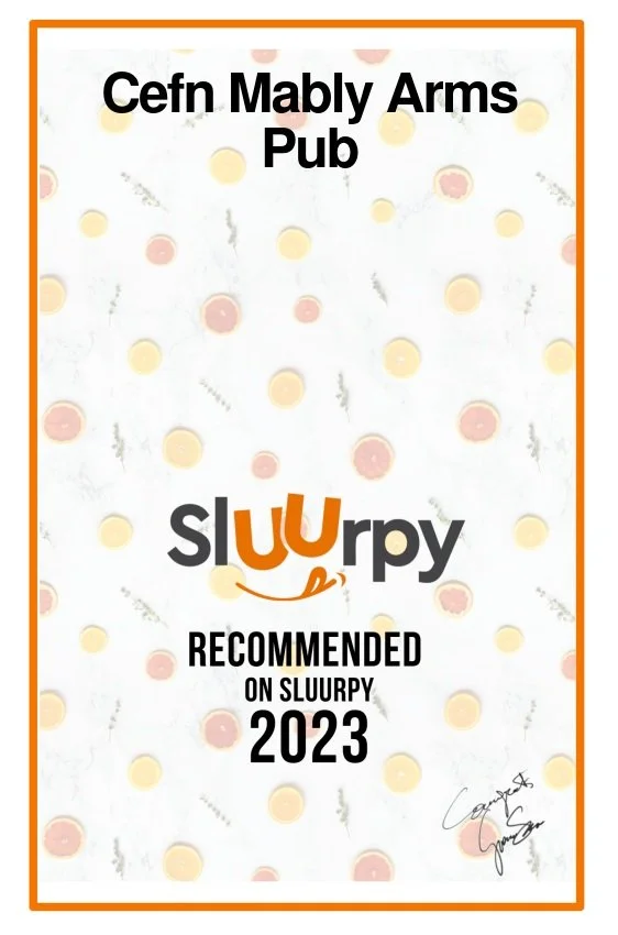 Certificate from Cefn Mably Arms Pub recommending Slϋrrpy on Slϋrrpy 2023, with a polka dot background and an orange border.