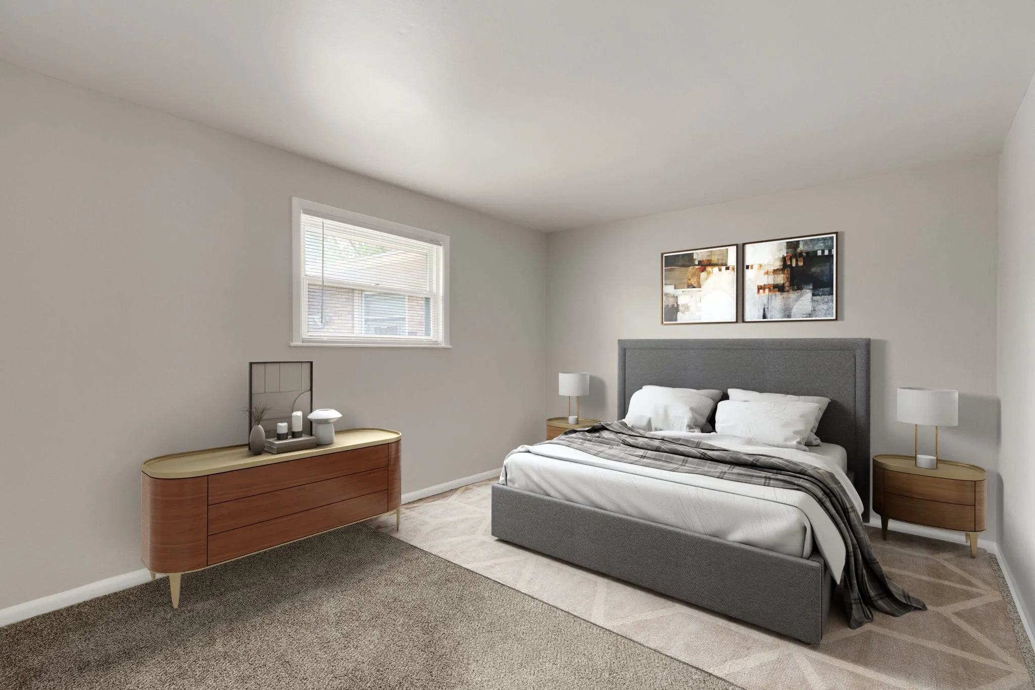A modern bedroom with a gray upholstered bed, white bedding, and two nightstands with lamps. There is a wooden dresser with decorative items and framed artwork above the bed. A window with blinds lets in natural light.