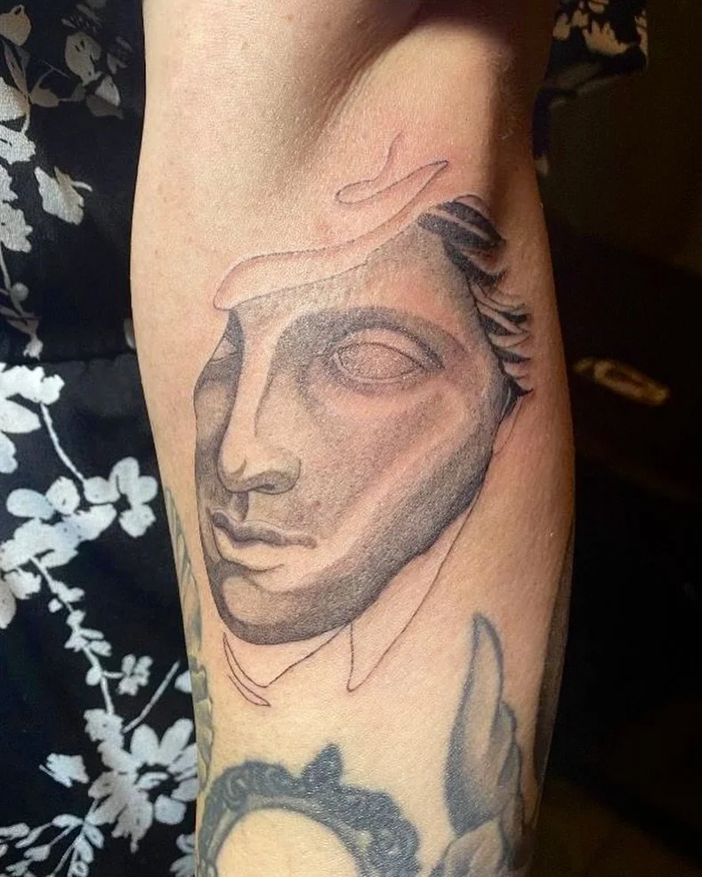 Black and grey realism tattoo of a classical statue face, inspired by Greek sculpture
.
.
Tattoo by: @ambrosia_tattoos 
.
.
Tag us next time you come by