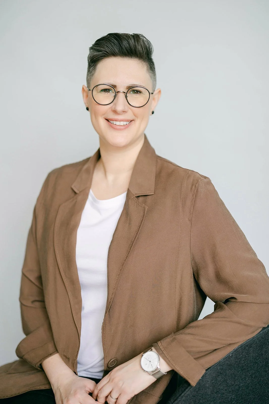 Myroslava Stadnyk_Registered_Psychotherapist_wearing a brown blazer_therapy_office