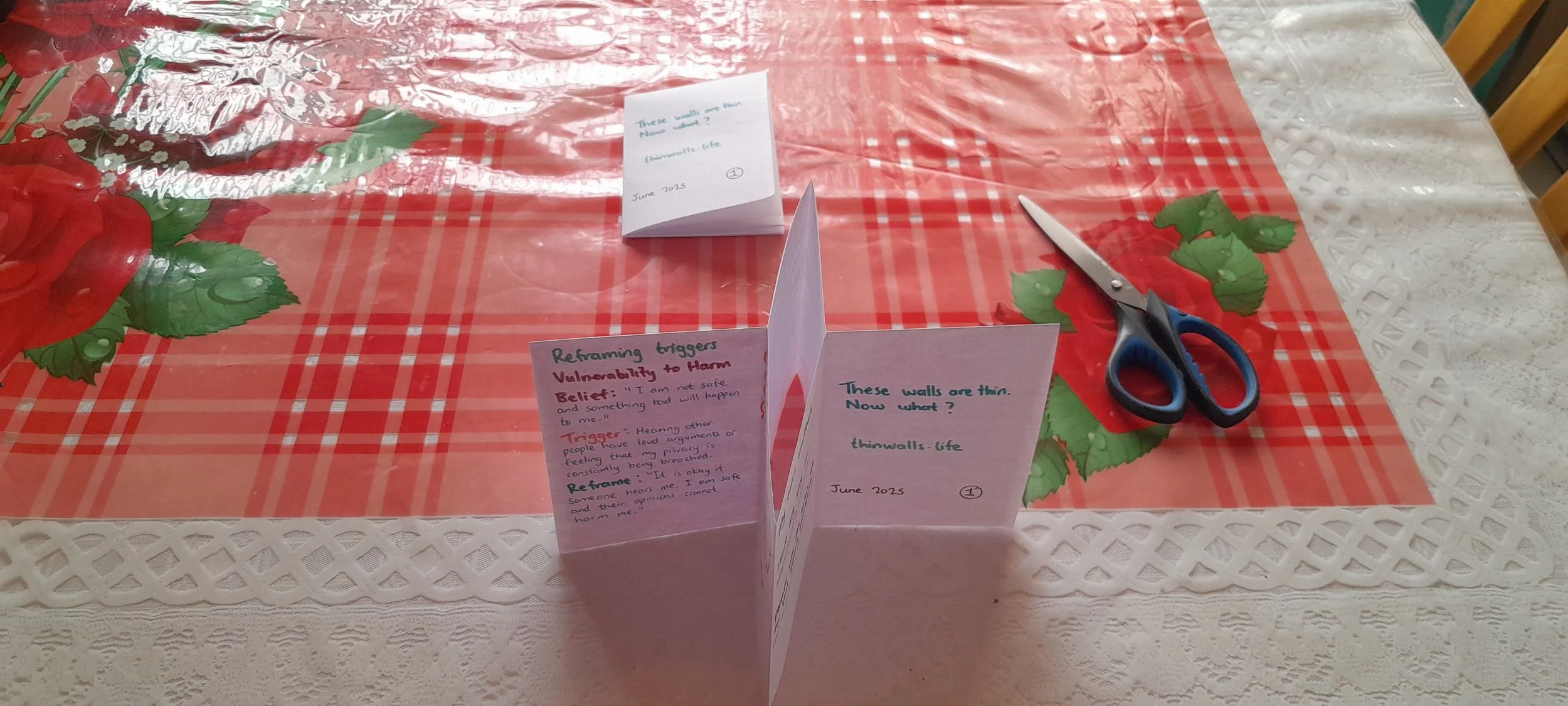 Folded paper collapsing into a small booklet shape with stacked pages.