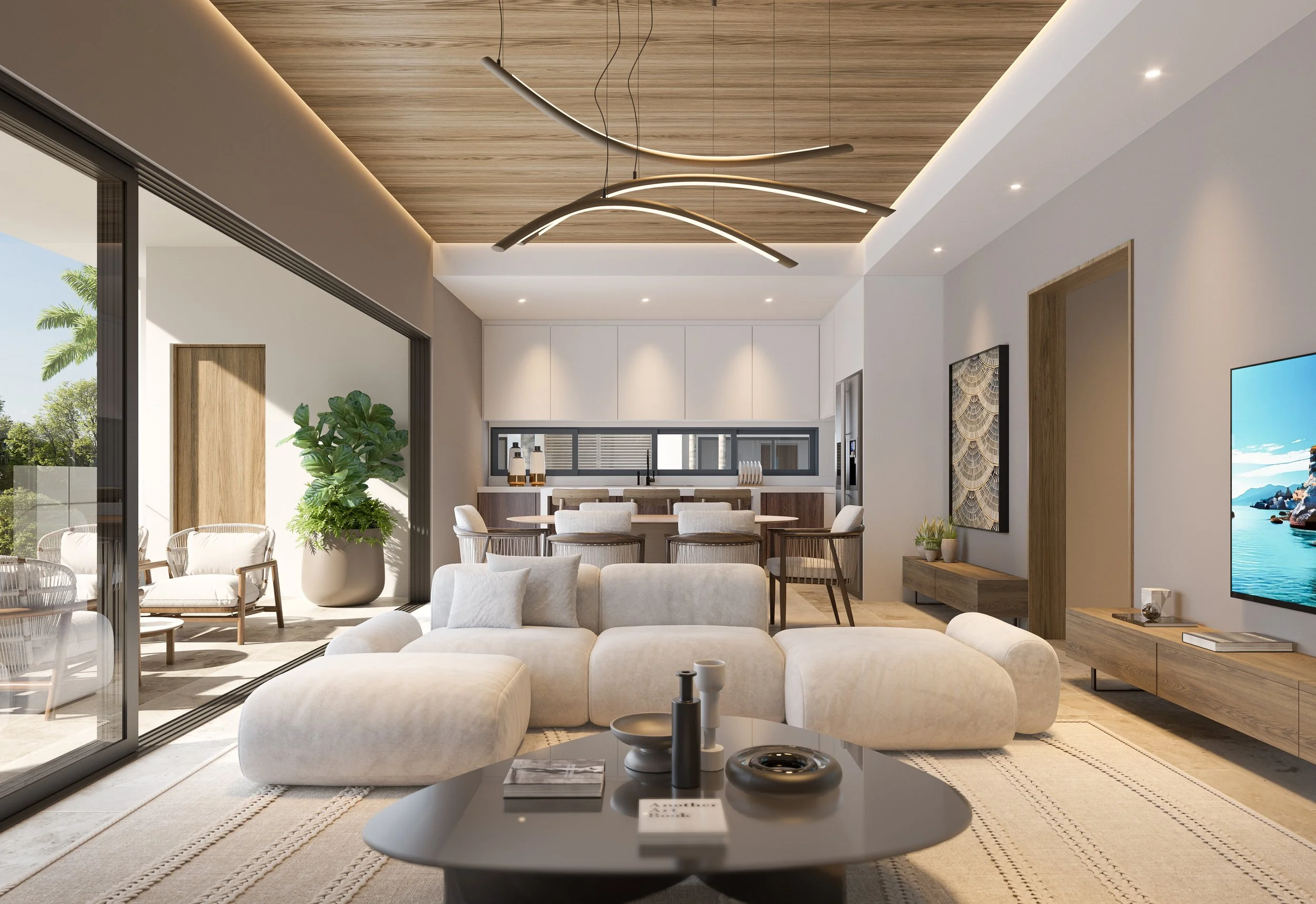 Modern open-plan living room with white sofa, beige ottomans, coffee table with decorative items, large sliding glass door leading to outdoor patio with chairs, dining area with chairs, kitchen with white cabinets, wooden accents, and large window.