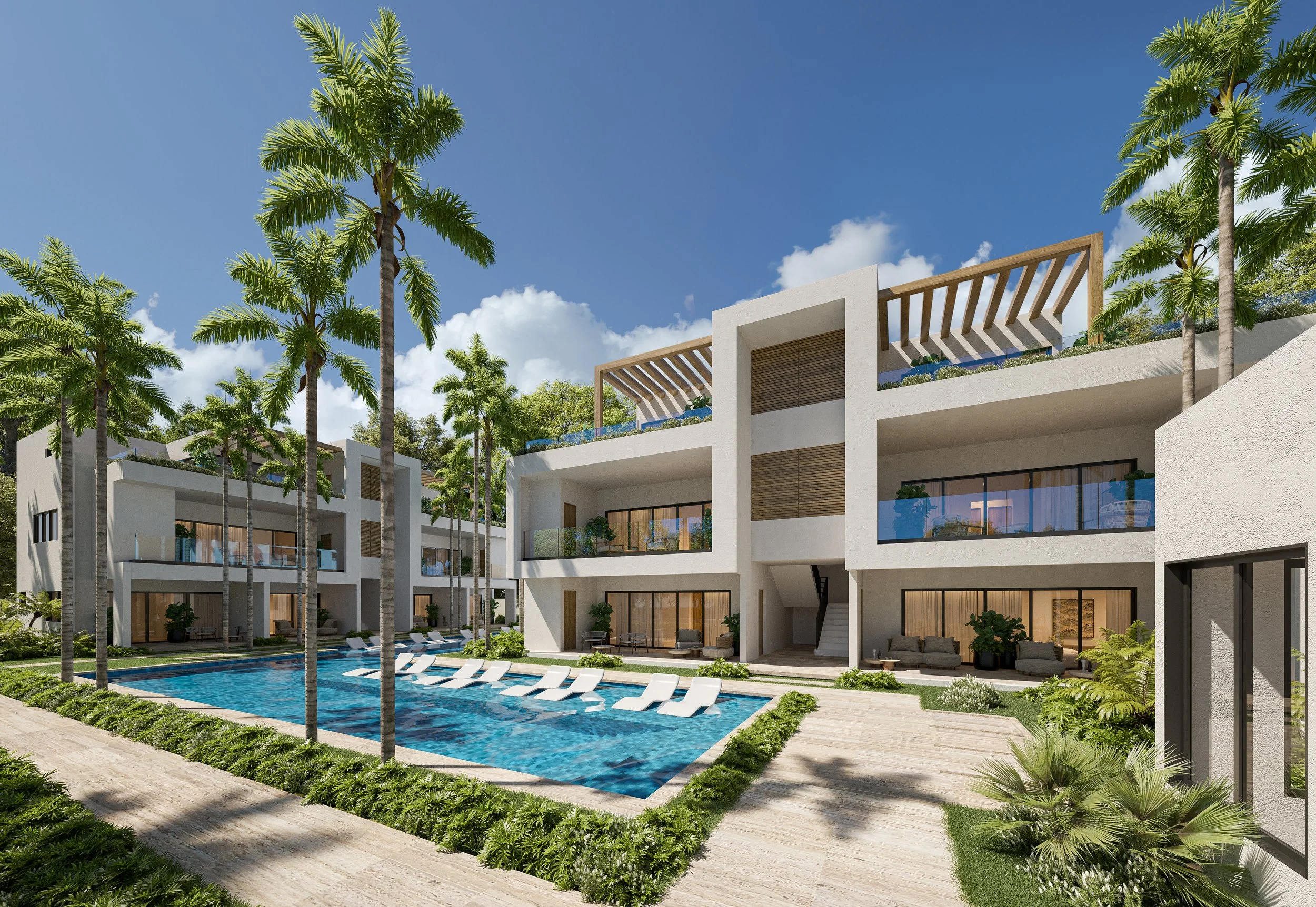 Modern residential apartment complex with a swimming pool, palm trees, and landscaped greenery under a partly cloudy blue sky.