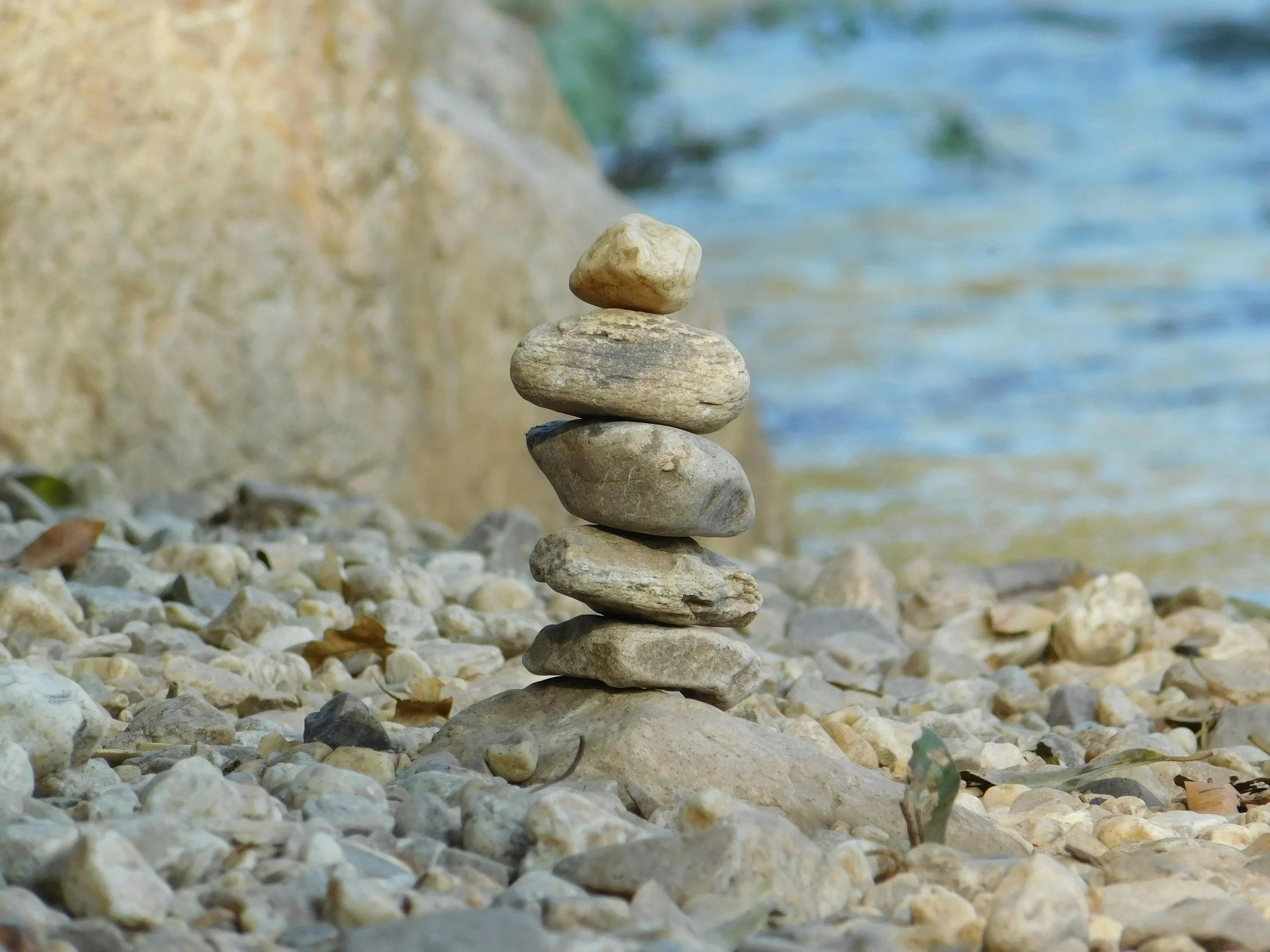 Stacked stones by the water.