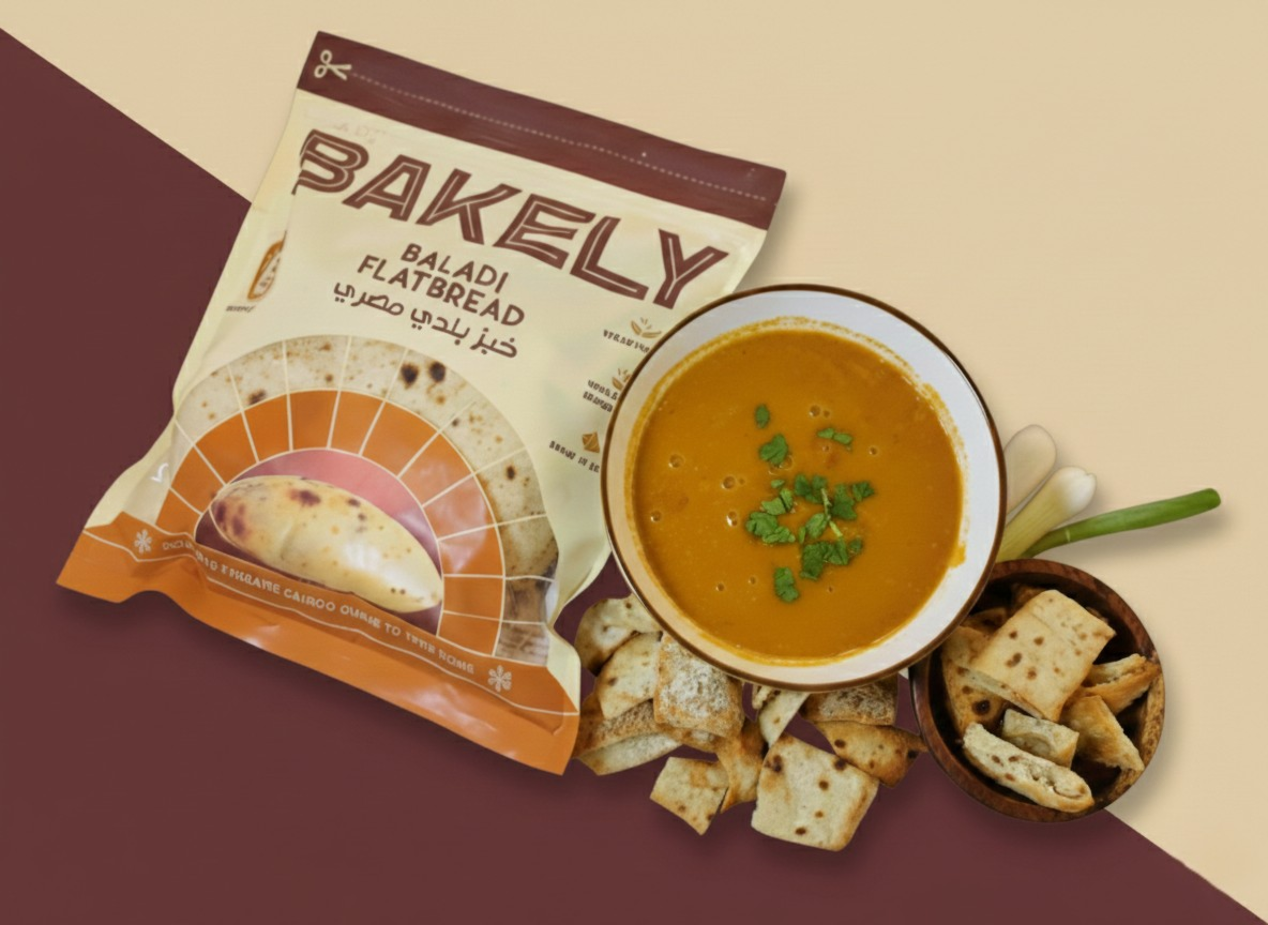 A bag of Balady Egyptian flatbread, a bowl of lentil soup garnished with cilantro, pita chips, sprigs of green onion, and chopped herbs on a divided tray.