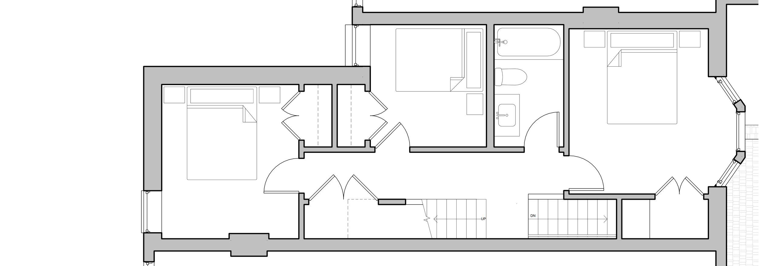 Floor plan of a house showing two bedrooms, a bathroom, and a staircase.