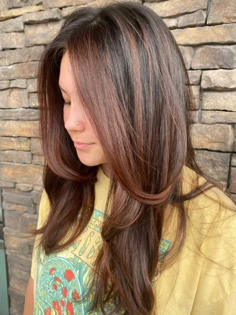 Dimensional brunette balayage with warm mocha tones on a client with a modern layered haircut.