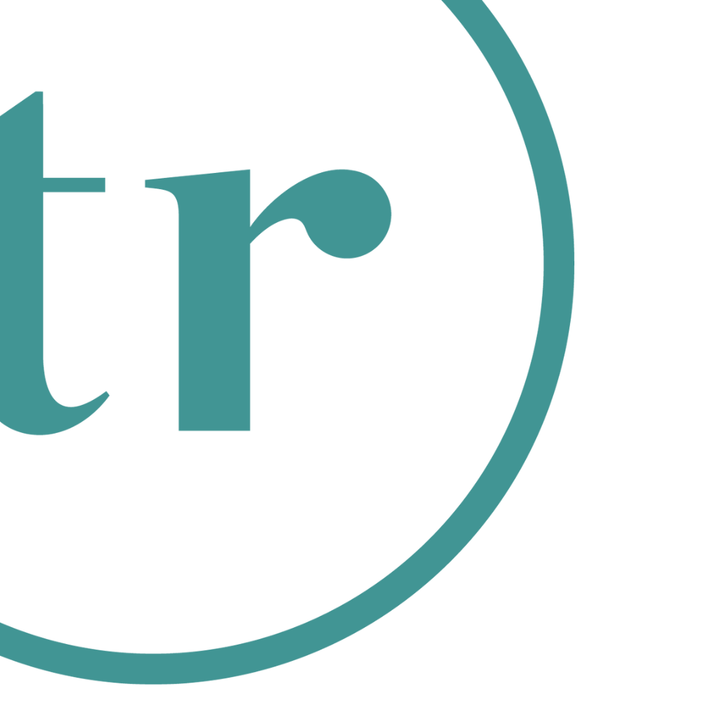 Close-up of a logo with stylized lowercase letter 't' and part of a lowercase letter 'r' inside a circle.