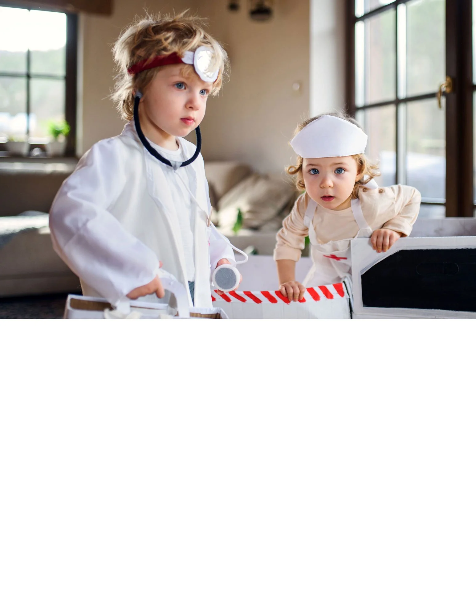 Close-up of an adult's hand holding the tiny hand of a baby, with the baby wearing a white long-sleeve outfit, emphasizing tenderness and connection.