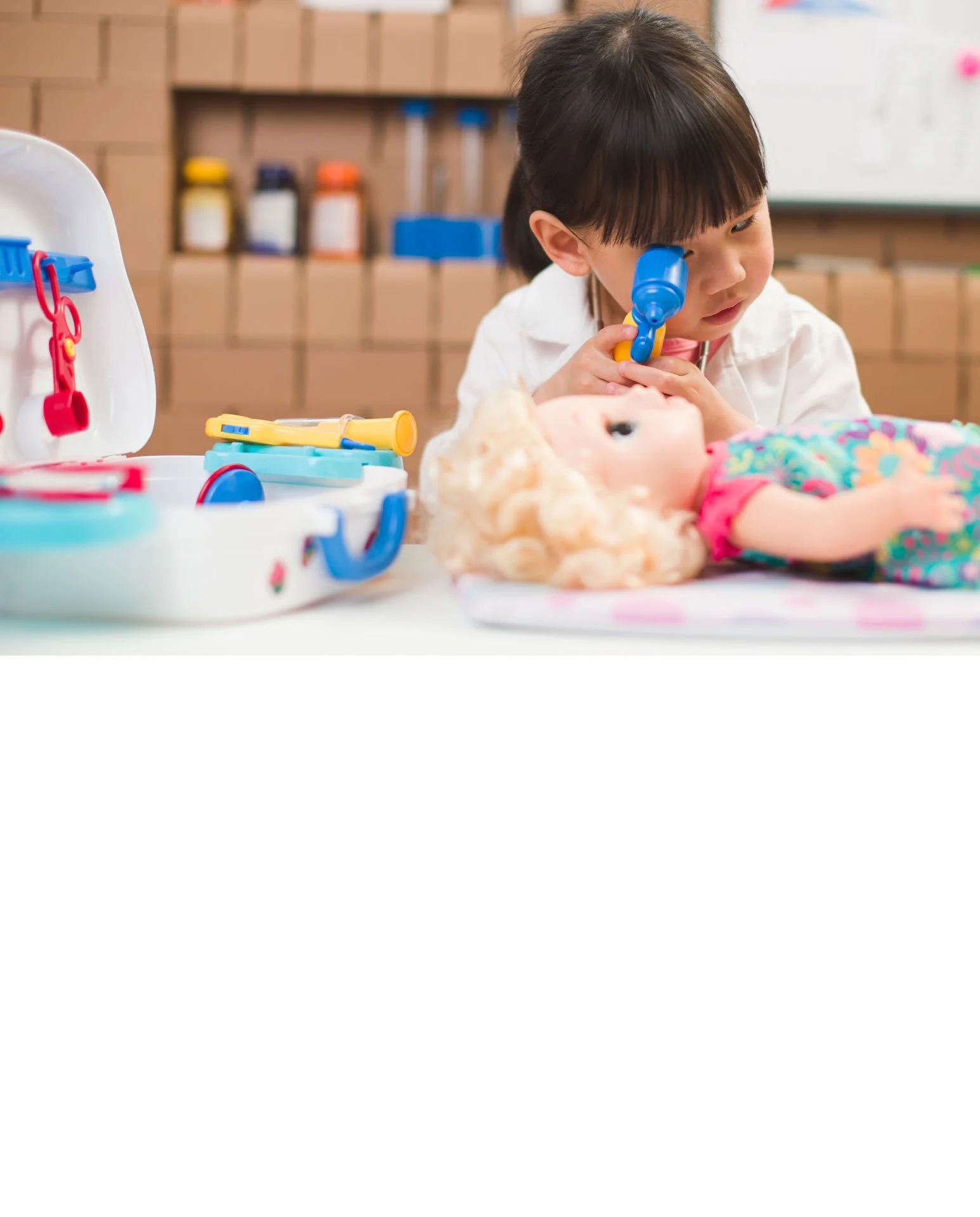 Doctor using a stethoscope on young girl in a clinical setting.