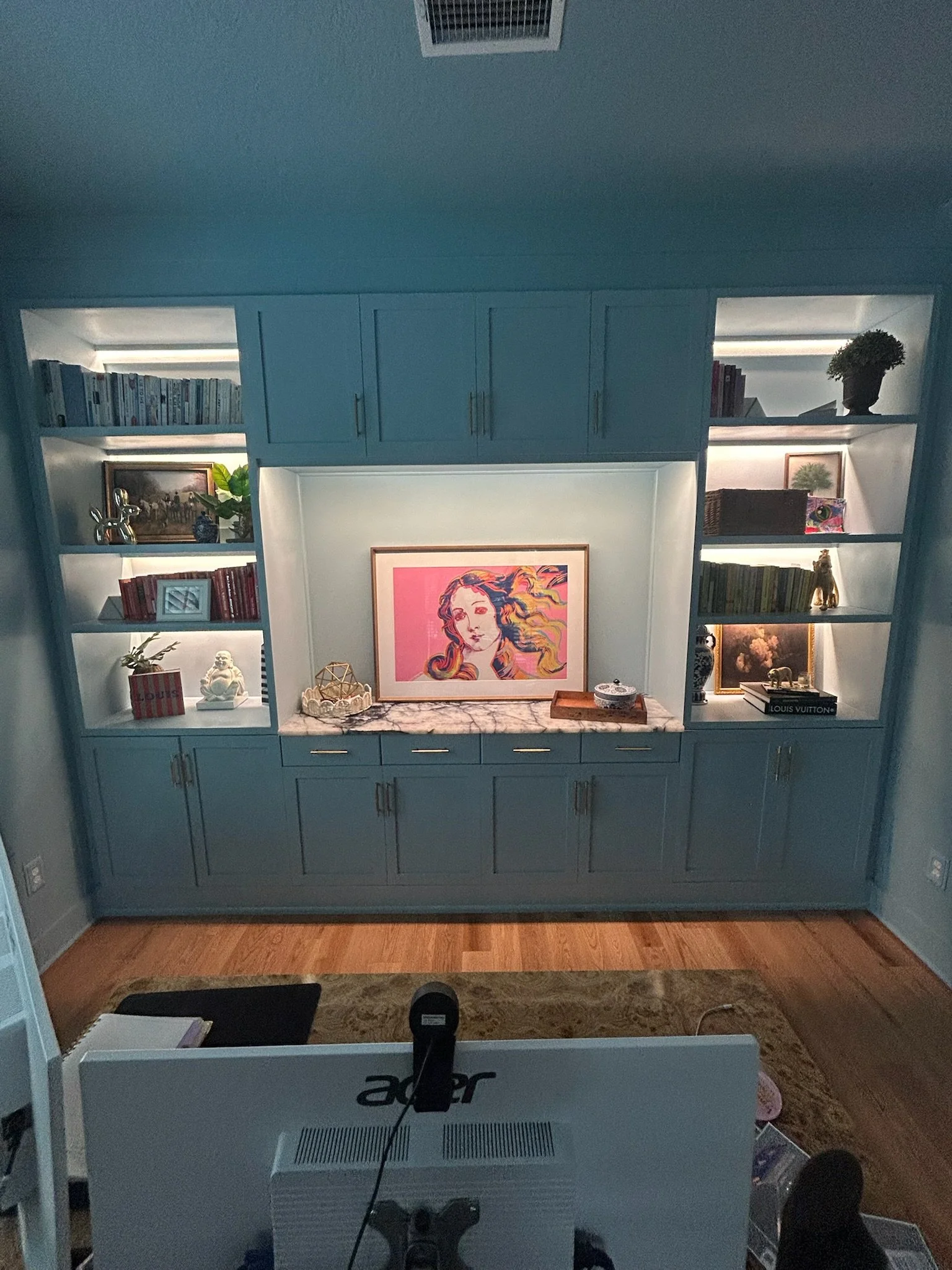 A decorated custom wall unit with bookshelves and cabinets