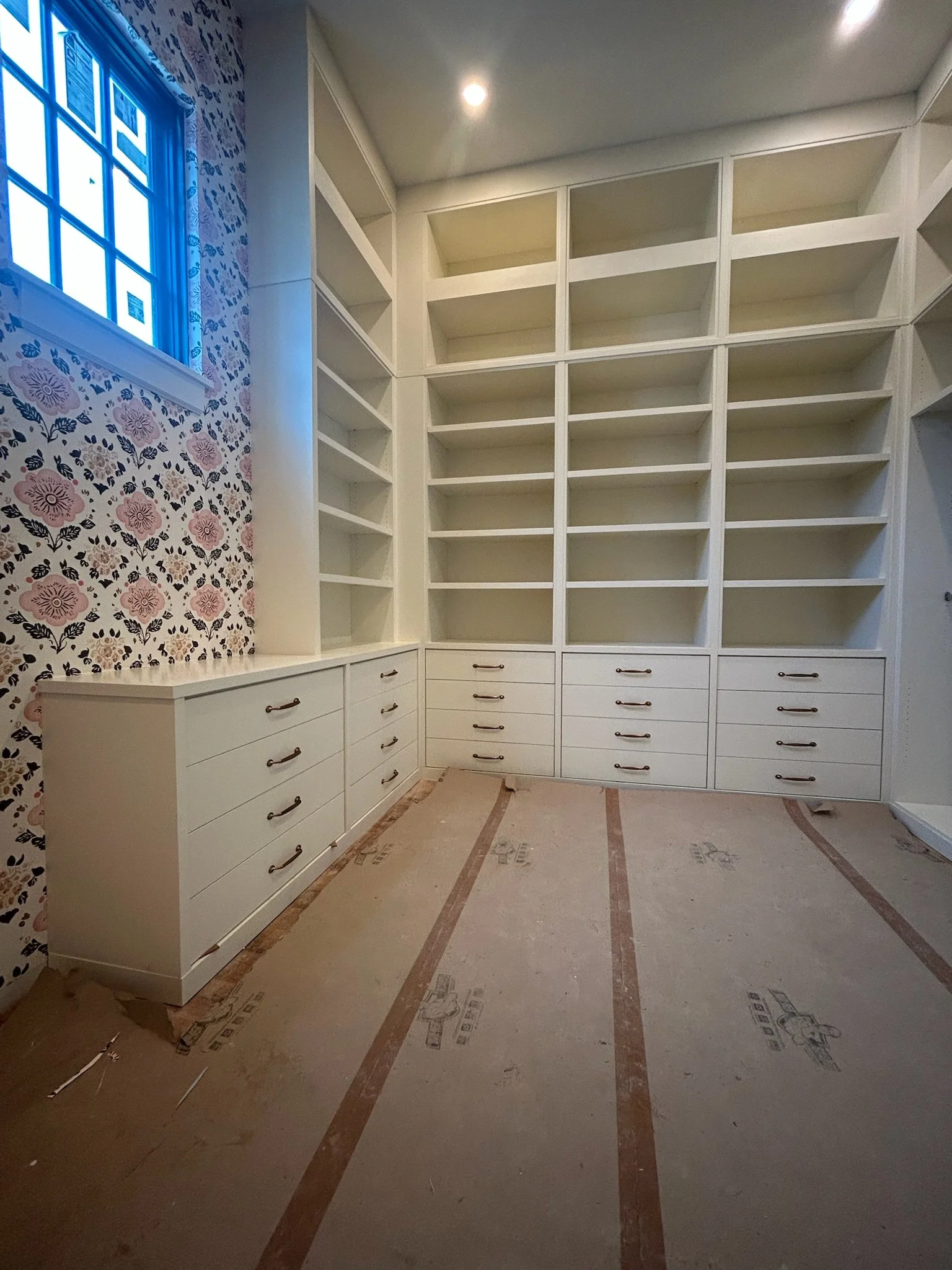 Custom closet with built-in shelves and cabinets and custom furniture