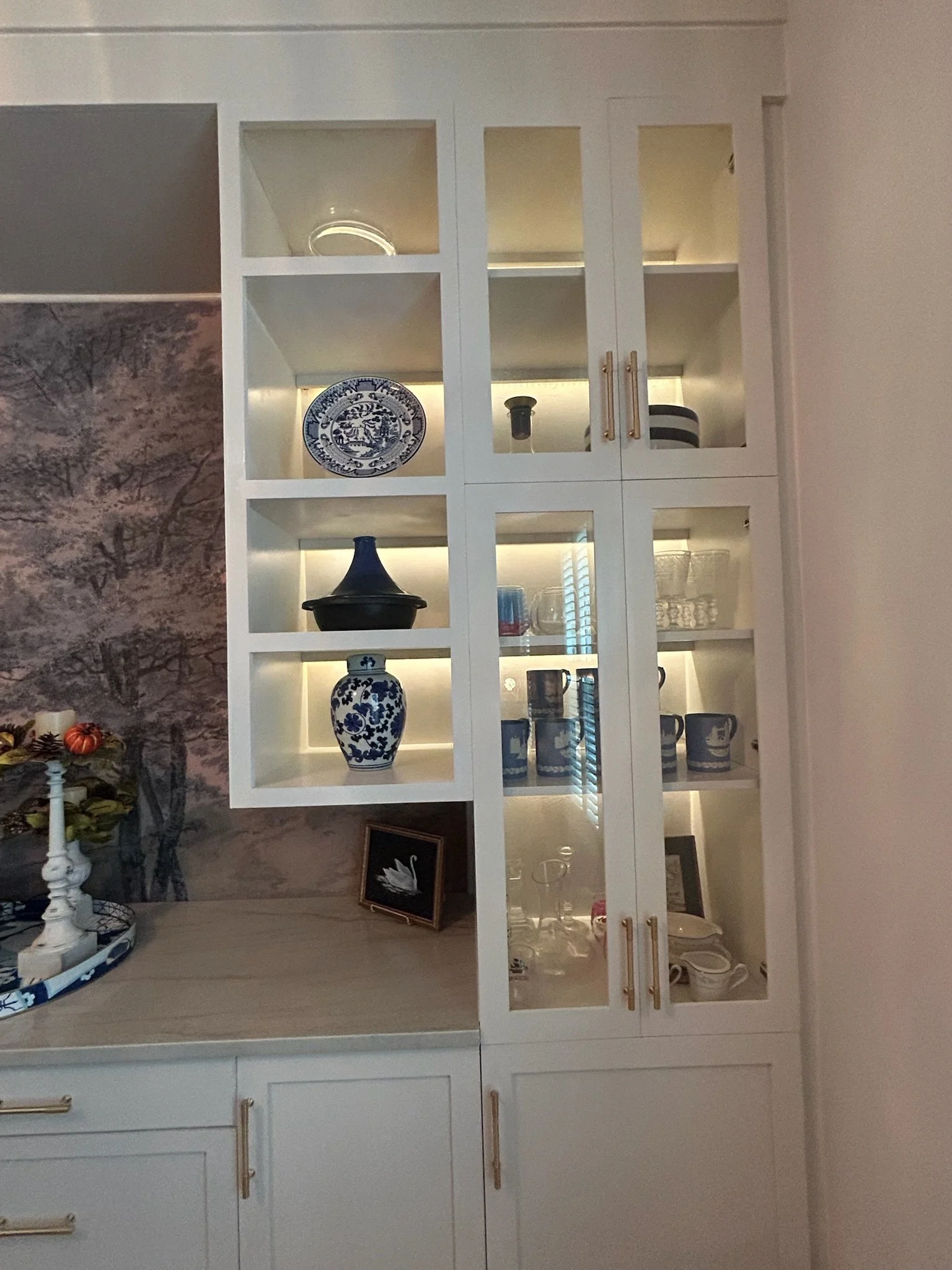 Custom living room cabinets with glass doors and drawers