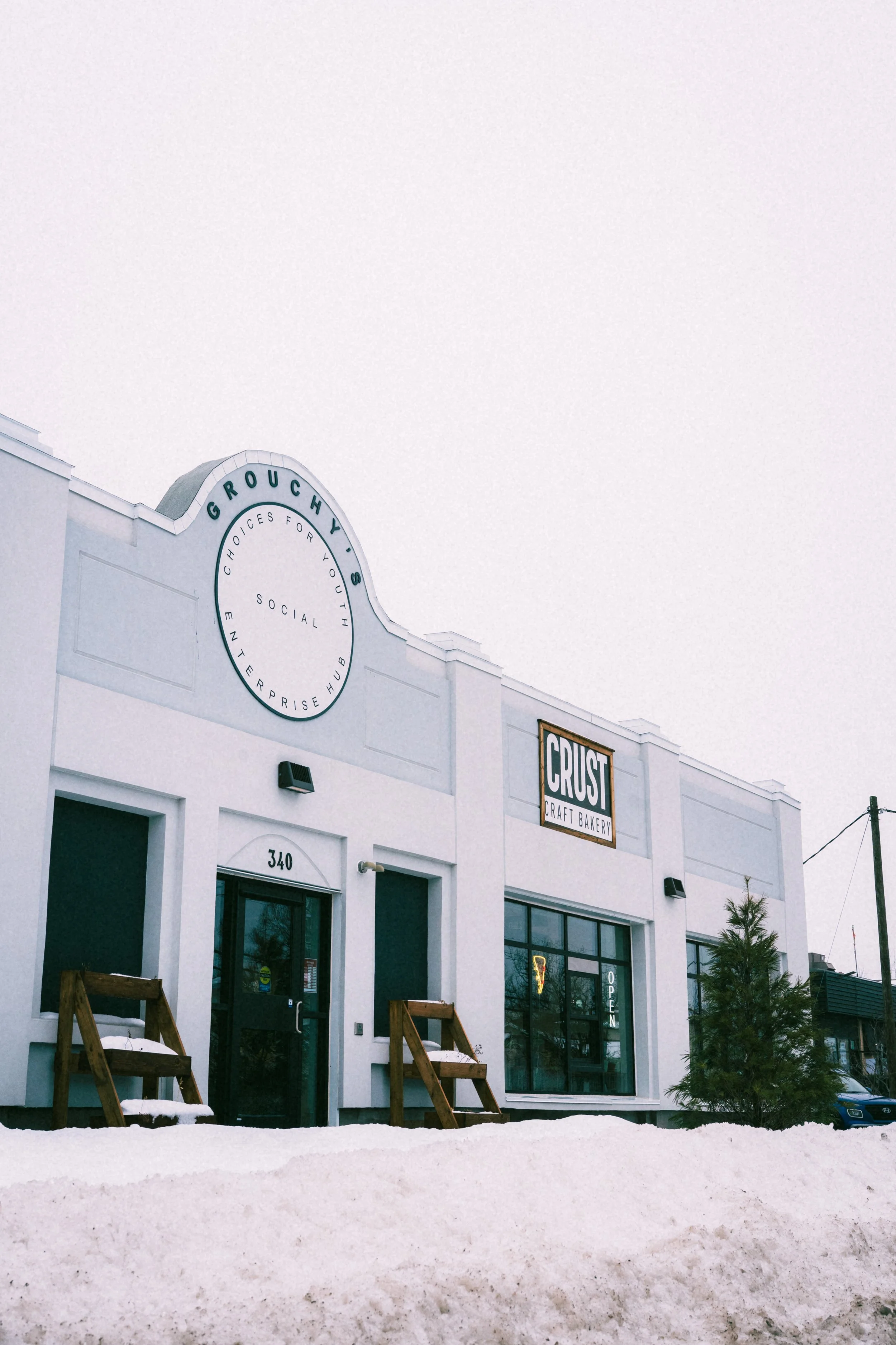 The exterior of Crust Craft Bakery under a gray sky.