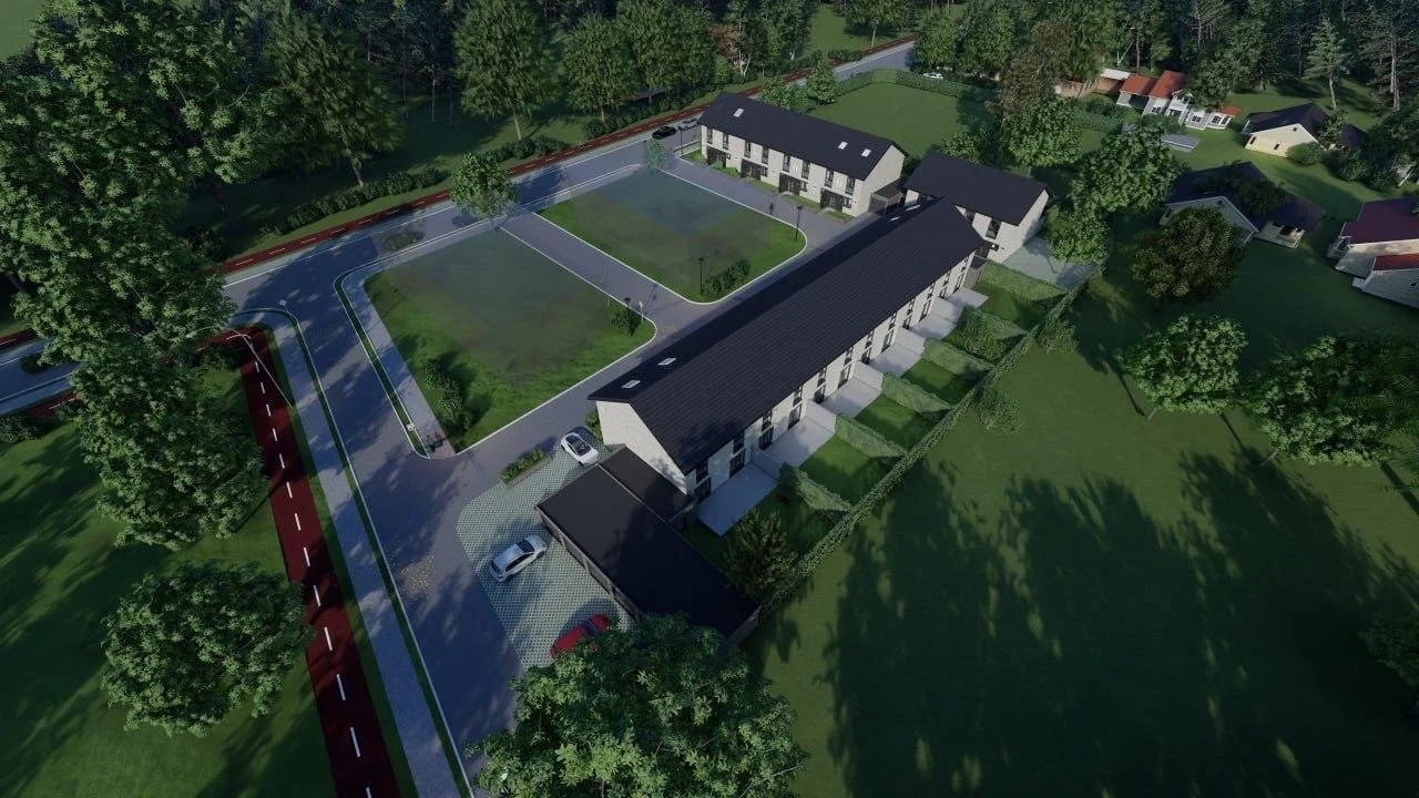 A computer-generated aerial view of a newly developed residential area with modern townhouses, parking spaces, green lawns, and surrounding trees.