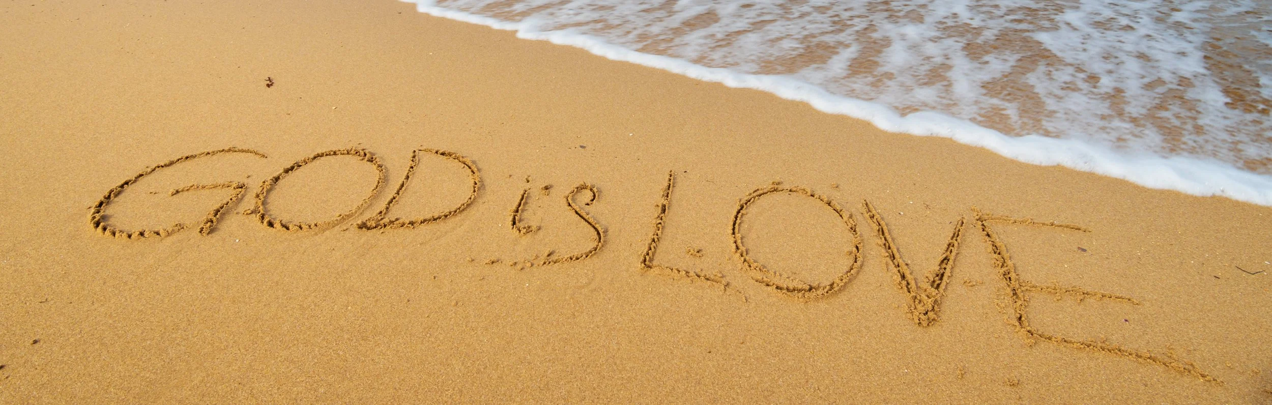 Ocean shoreline with God is love theme