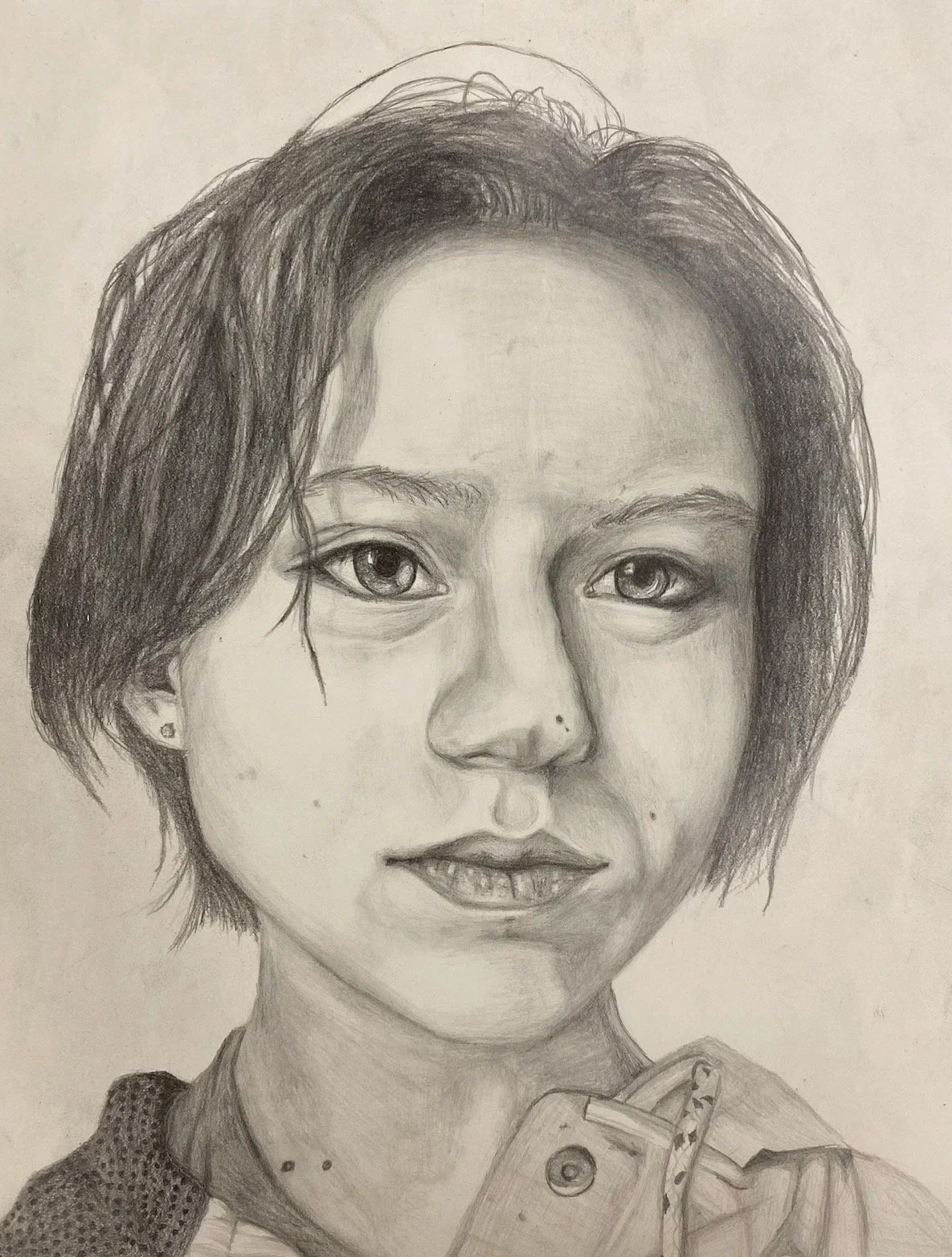 Self-portrait of the artist, Therese Franks. A pencil drawing in which the young woman has short hair, earrings, and wearing a sweater.