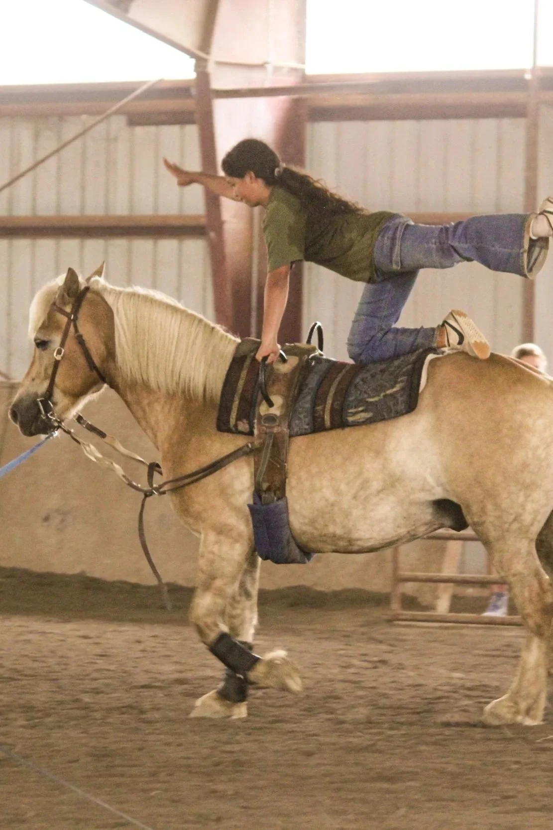 girl doing gymnastics on horse