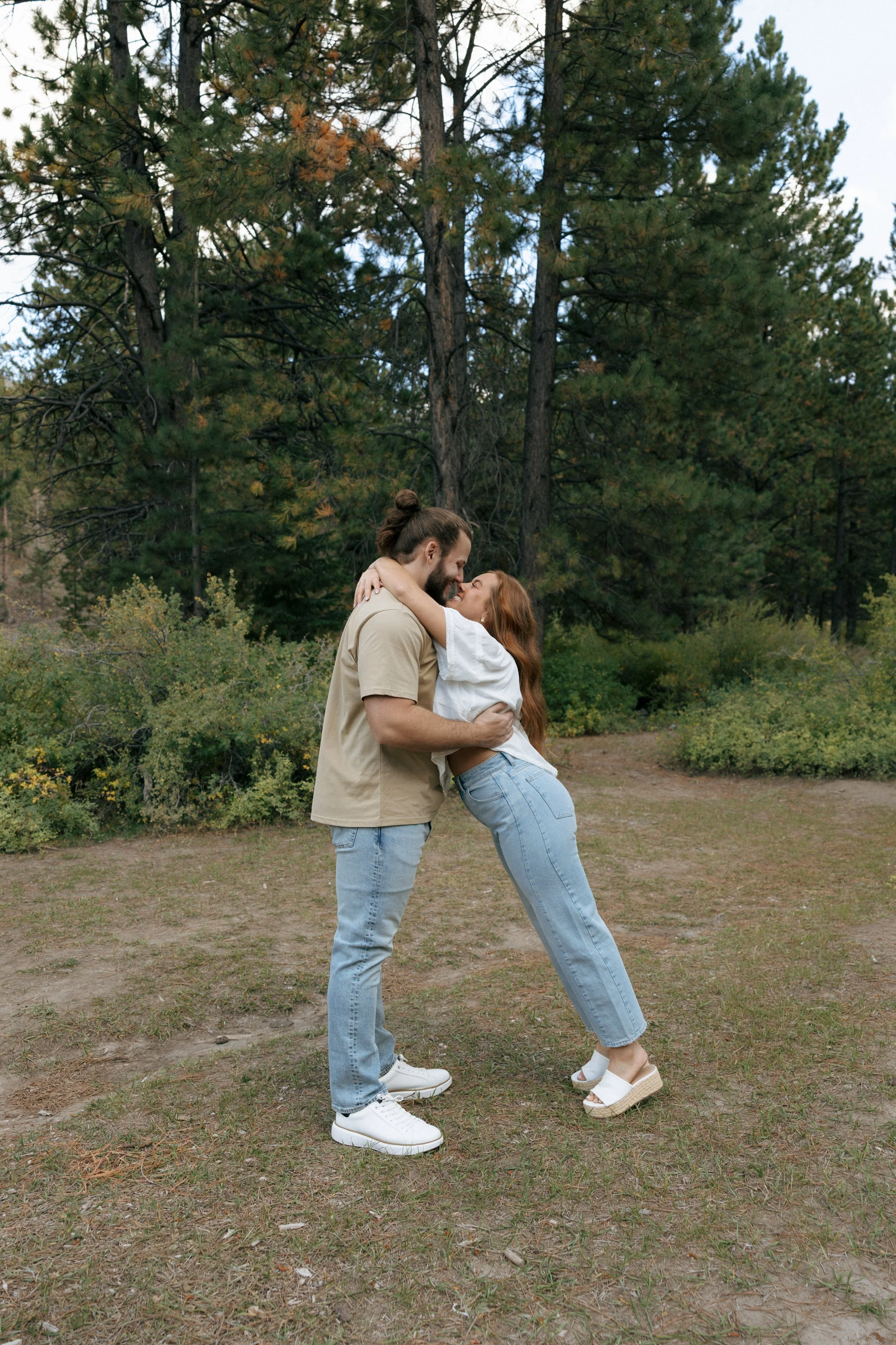 A couple sharing a kiss and embracing outdoors at Mt Charleston.