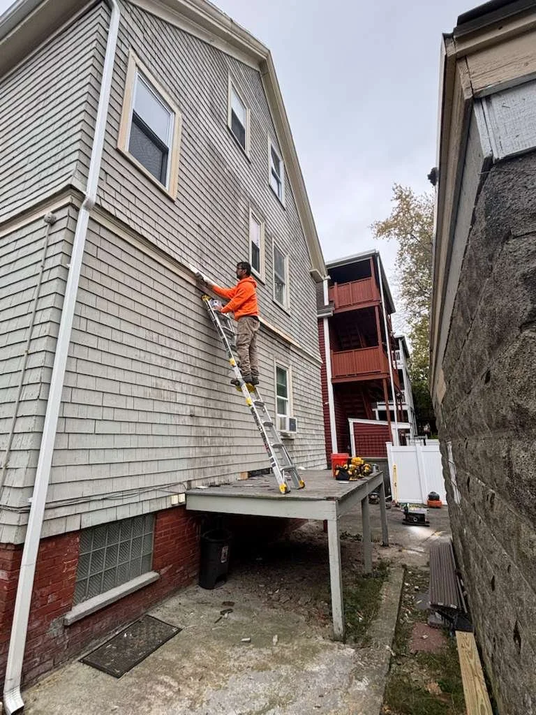 Rear wall patched and sealed during porch removal in Somerville