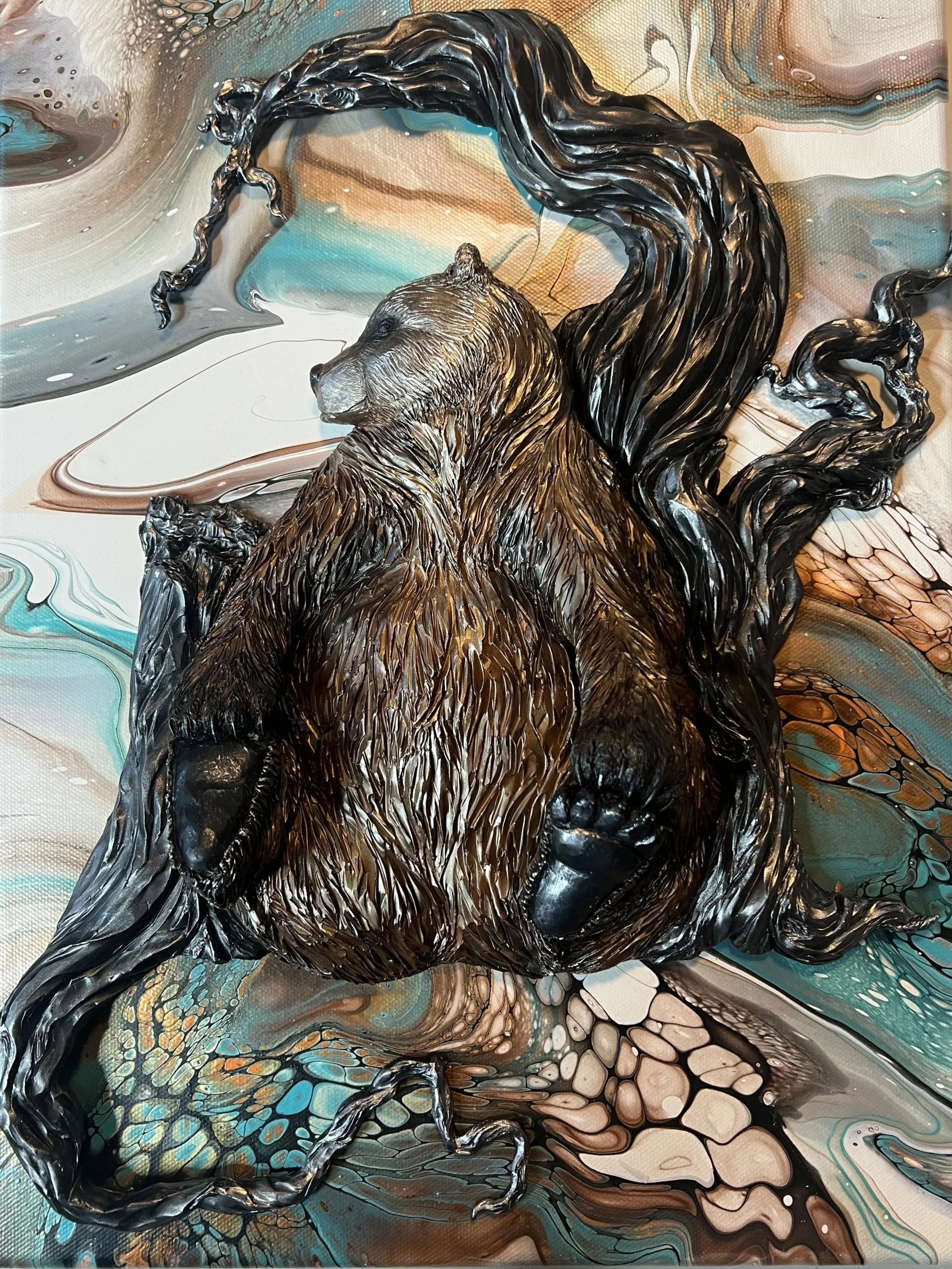 A mixed media artwork featuring a 3D bear sculpture with detailed fur and claws, set against an abstract colorful background.