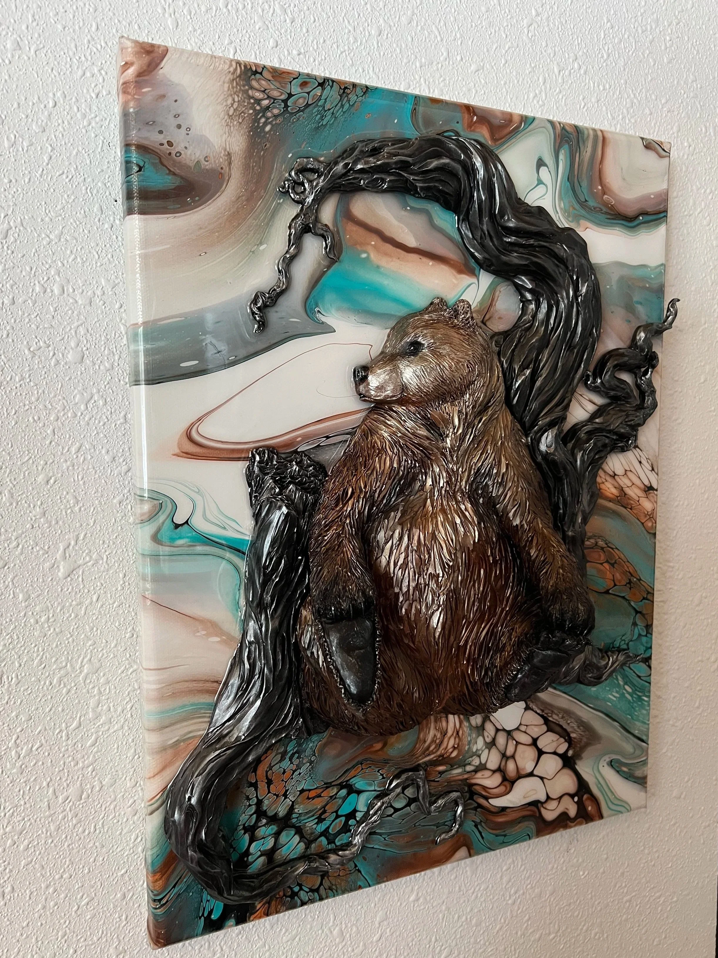 A mixed-media artwork depicting a bear with a flowing black mane against a colorful, swirling abstract background
